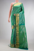 Green Dual Tone Kanchipuram Silk Saree with Zari Brocade on the body and Zari Border.  displayed on a mannequin