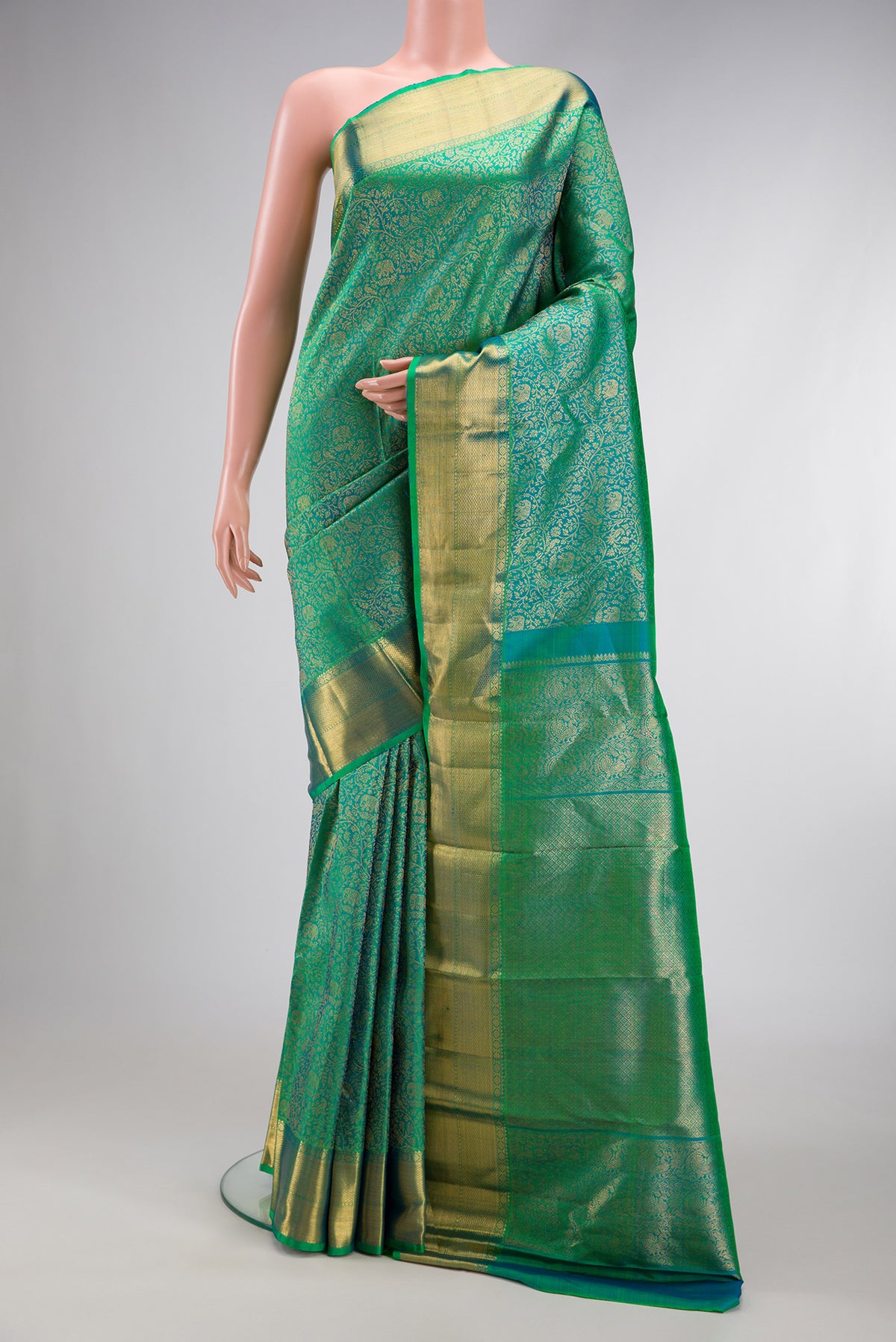 Green Dual Tone Kanchipuram Silk Saree with Zari Brocade on the body and Zari Border.  displayed on a mannequin