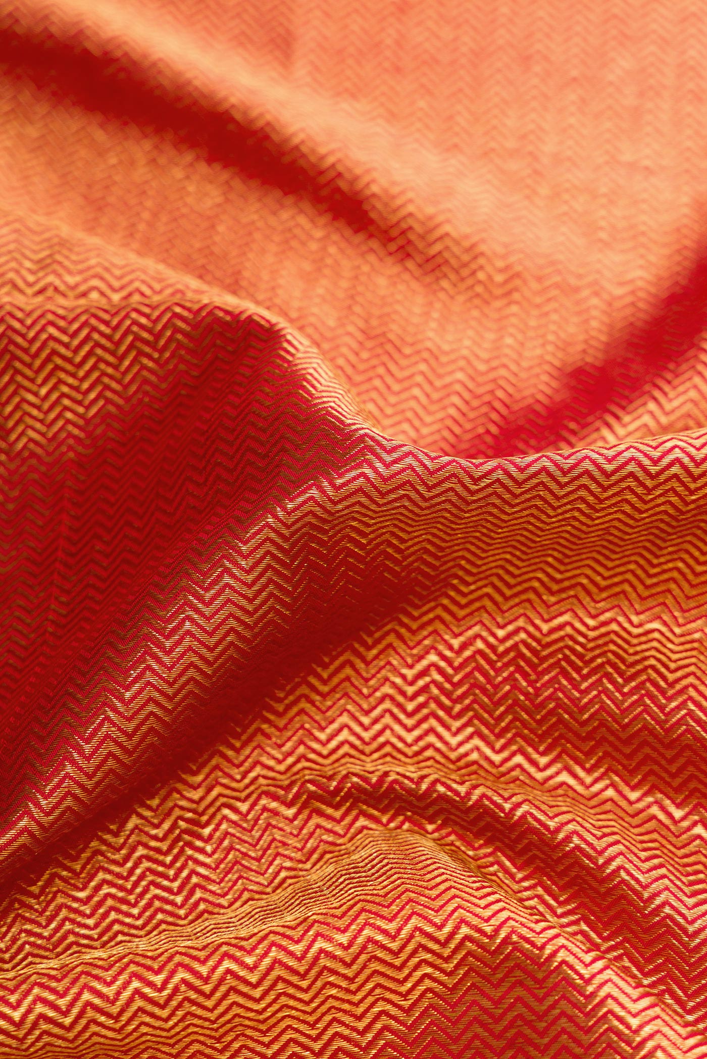 Close up of Dark Pink Dual Tone Kanchipuram Silk Saree with Zari Brocade on the body and Zari Border.  displaying folds