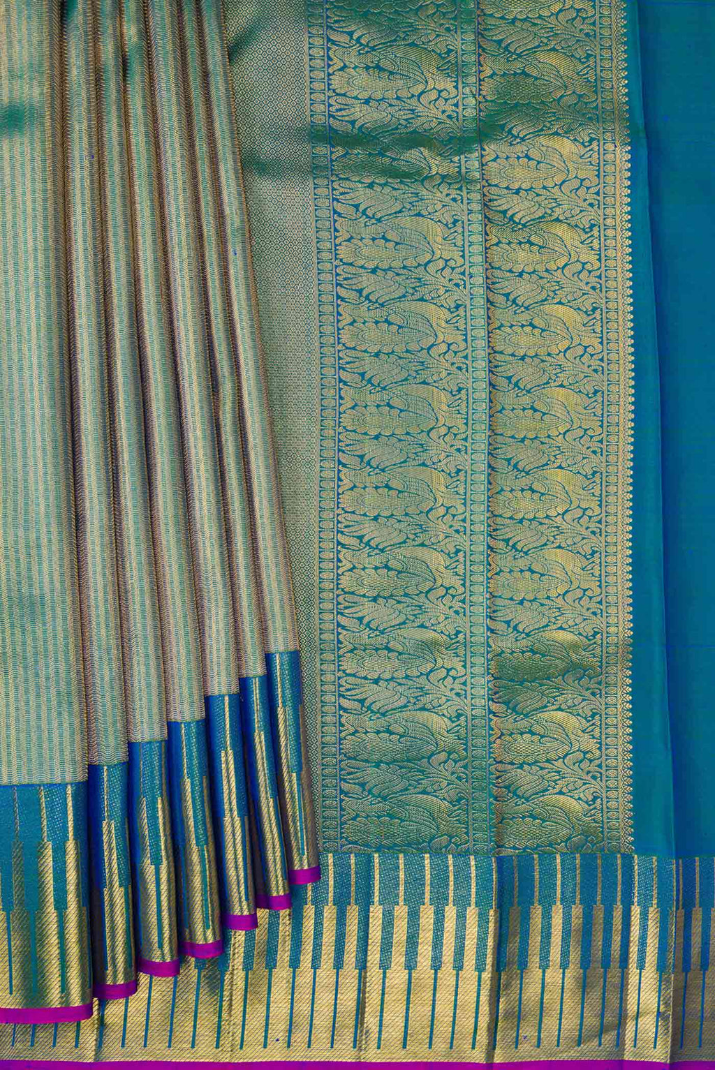 Pleats and pallu of Peacock Blue Dual Tone Kanchipuram Silk Saree with Zari Brocade on the body and Zari Border. 