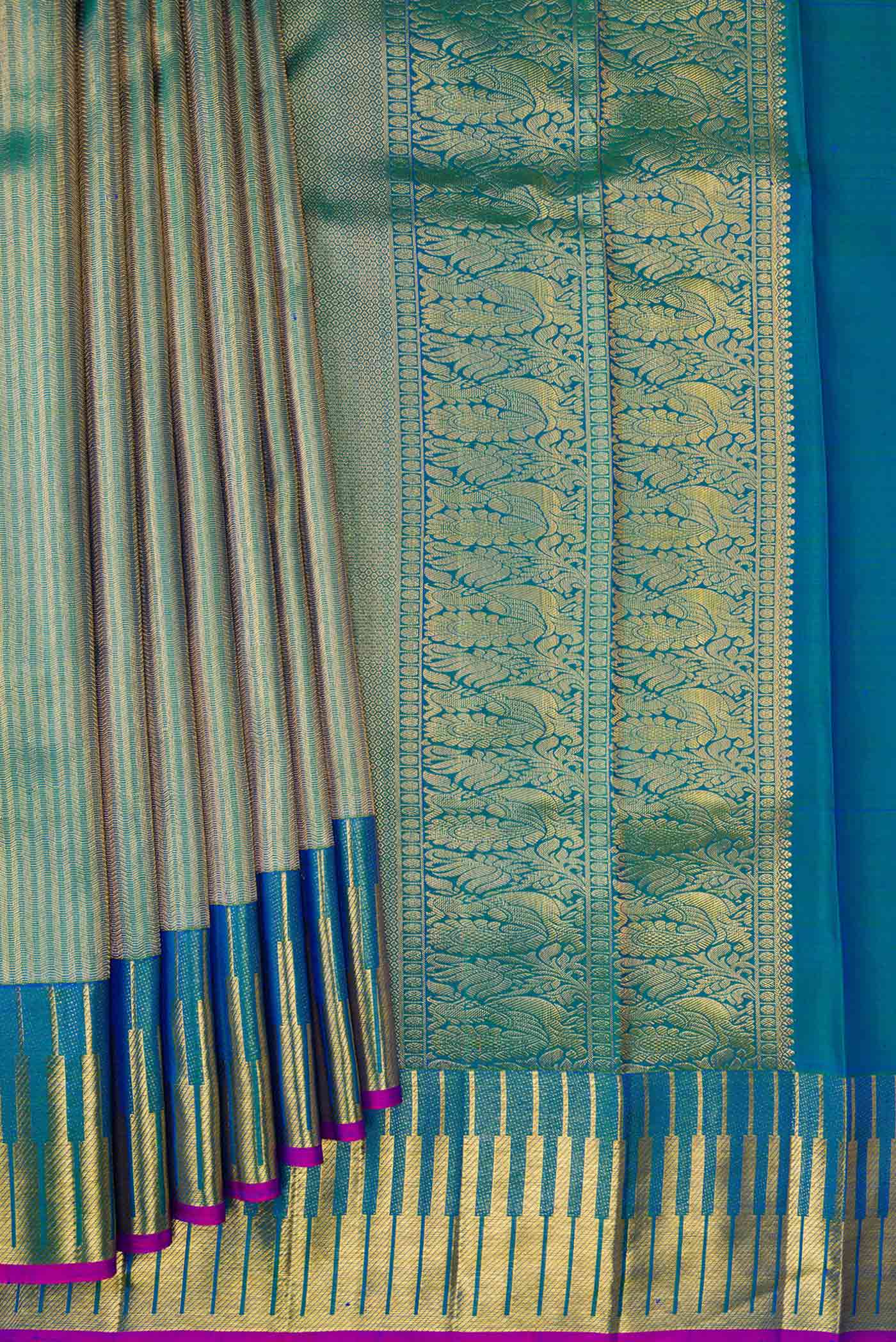 Pleats and pallu of Peacock Blue Dual Tone Kanchipuram Silk Saree with Zari Brocade on the body and Zari Border. 