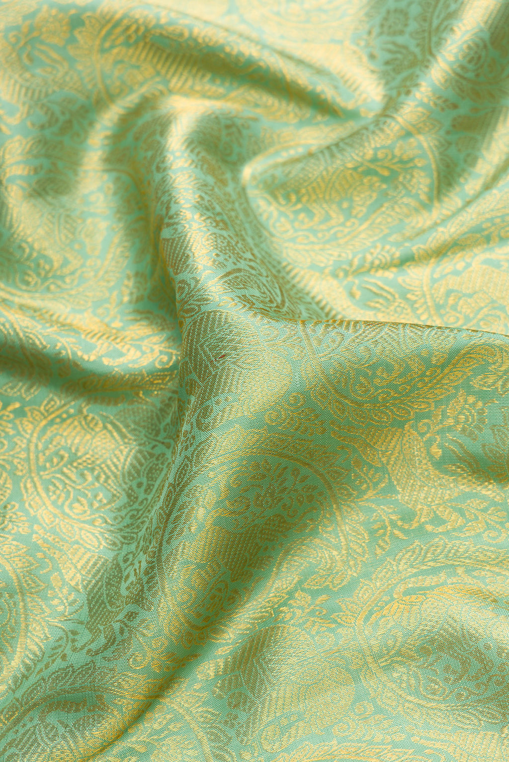 Close up of Pista Green Dual Tone Kanchipuram Silk Saree with Zari Brocade on the body and Zari Border.  displaying folds