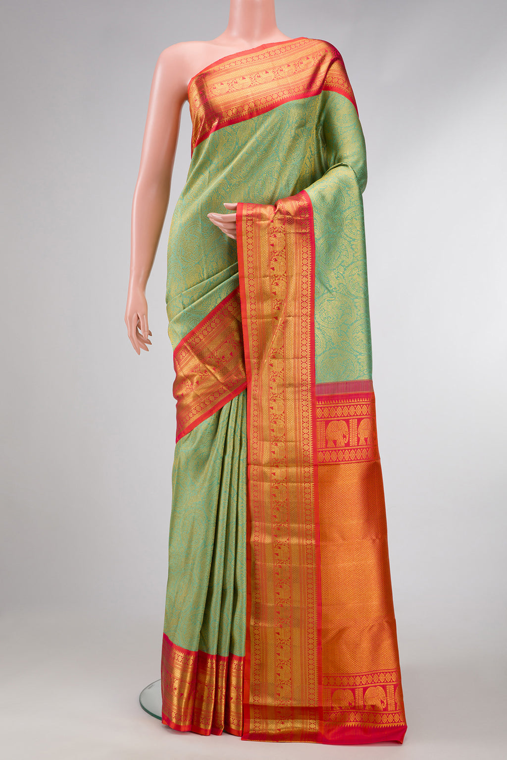 Pista Green Dual Tone Kanchipuram Silk Saree with Zari Brocade on the body and Zari Border.  displayed on a mannequin