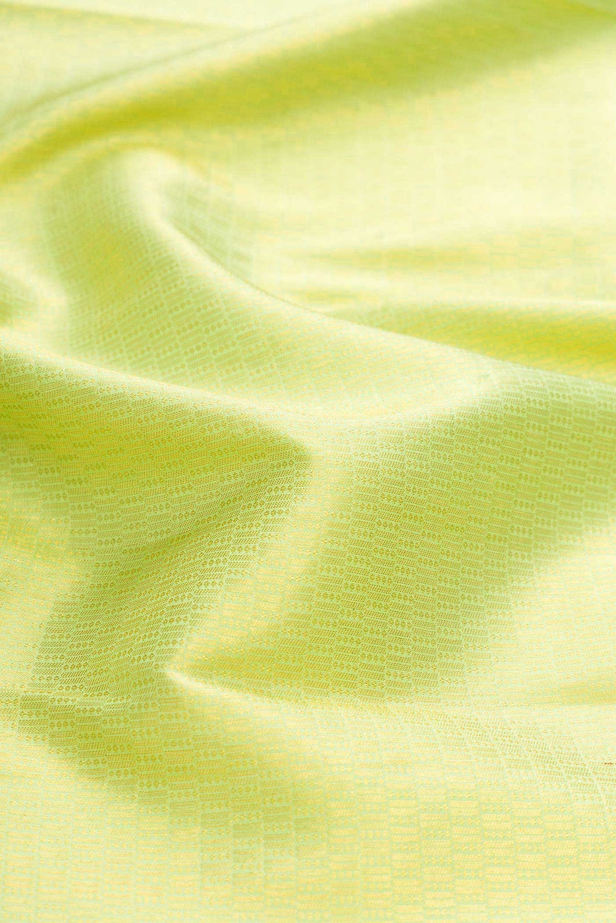 Close up of Green Kanchipuram Silk Saree with Zari Brocade on the body and Zari Border displaying folds