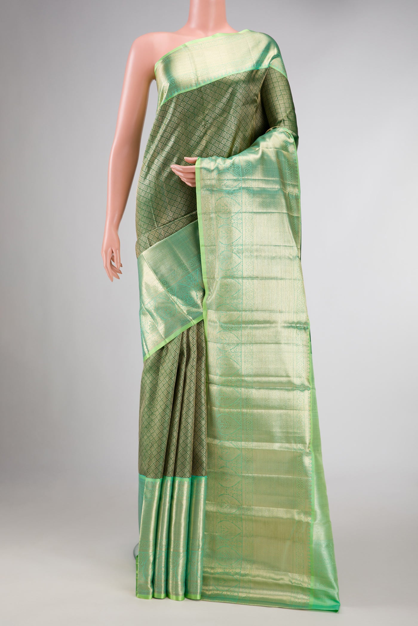 Green Dual Tone Kanchipuram Silk Saree with Zari Brocade on the body and Zari Border displayed on a mannequin