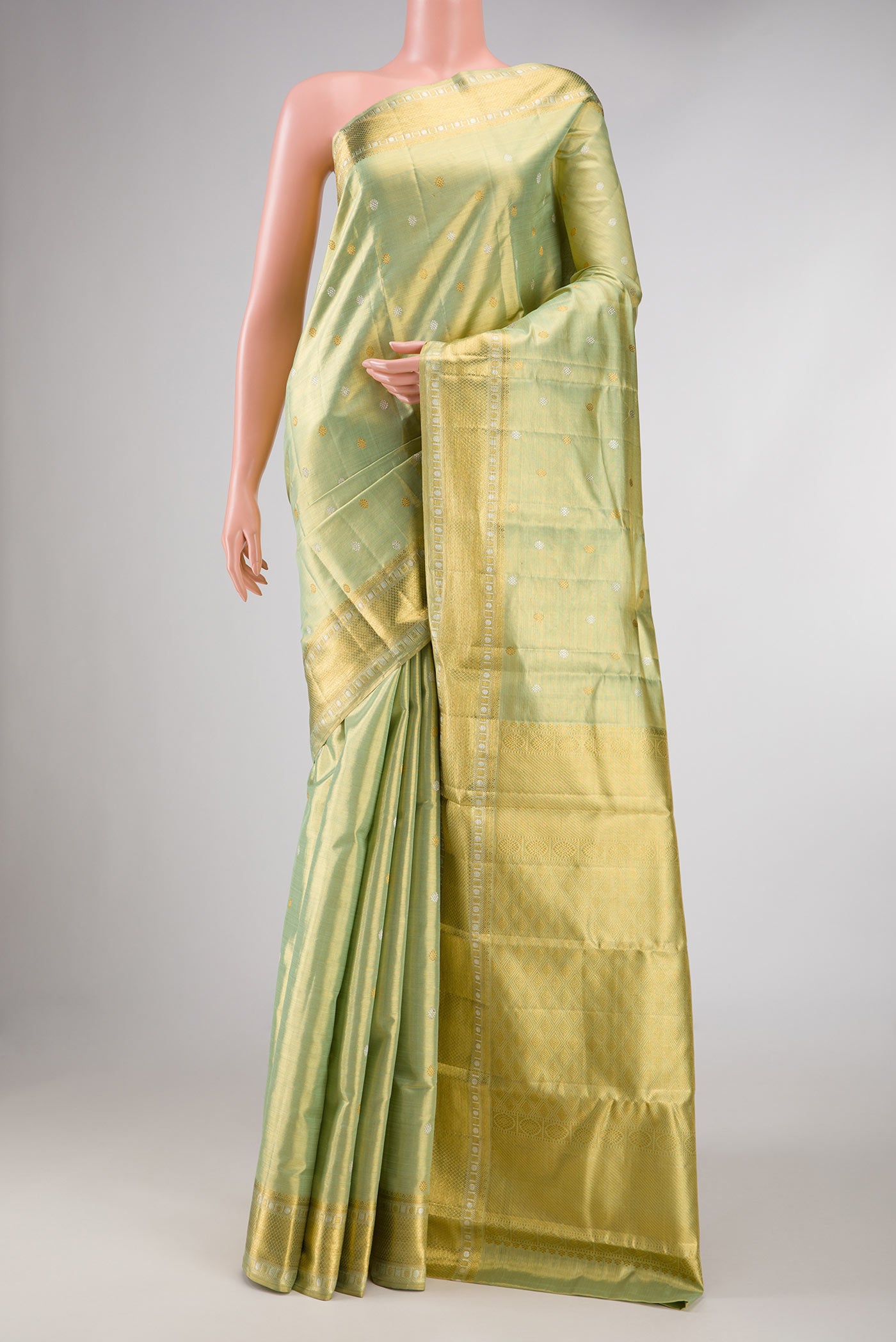 Pista Green Dual Tone Kanchipuram Silk Saree with Zari Butta on the body and Zari Border displayed on a mannequin