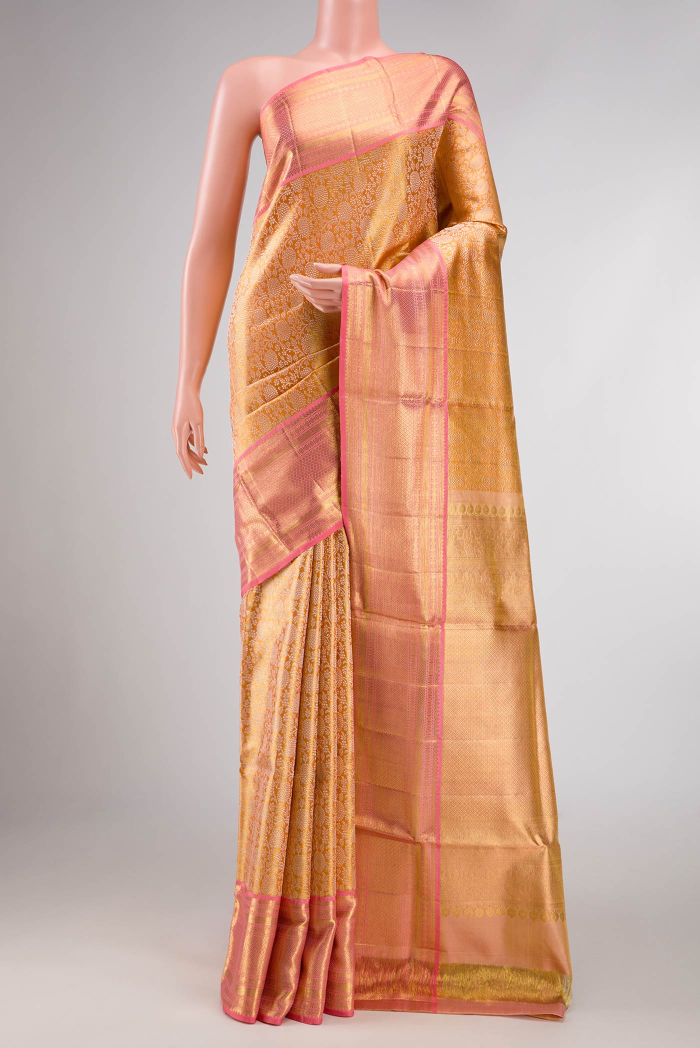 Gold Dual Tone Kanchipuram Silk Saree with Zari Brocade on the body and Zari Border displayed on a mannequin