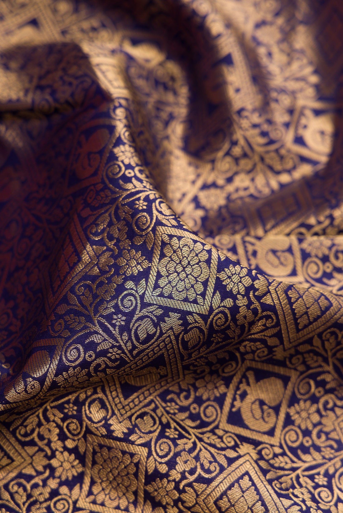 Close up of Navy Blue Kanjivaram Silk Saree with Zari Brocade on the body and Zari Border.  displaying folds
