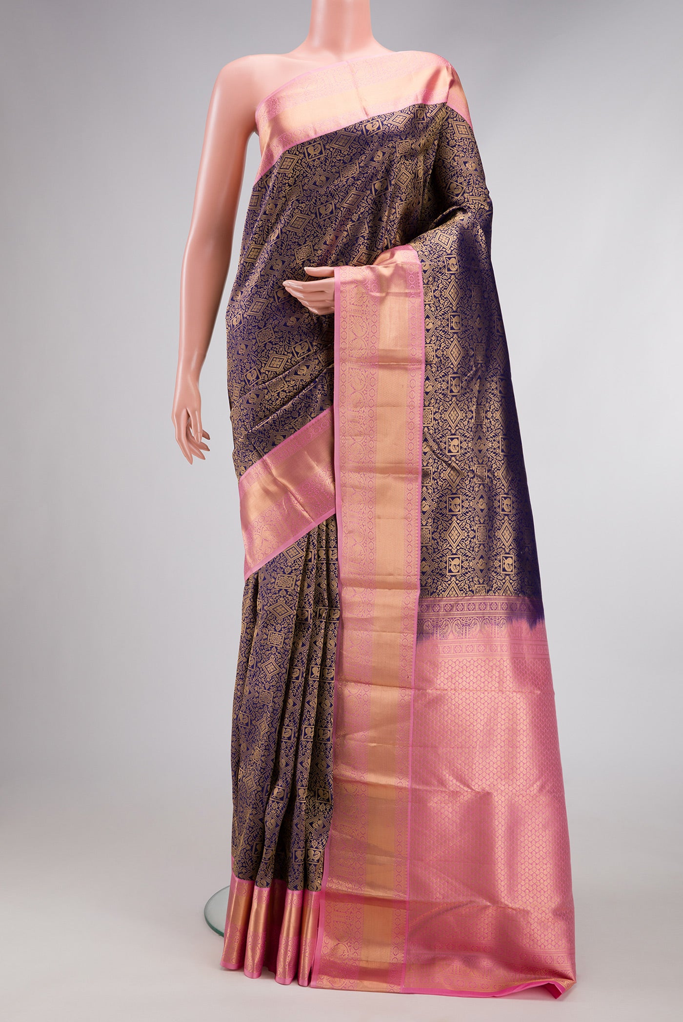 Navy Blue Kanjivaram Silk Saree with Zari Brocade on the body and Zari Border.  displayed on a mannequin