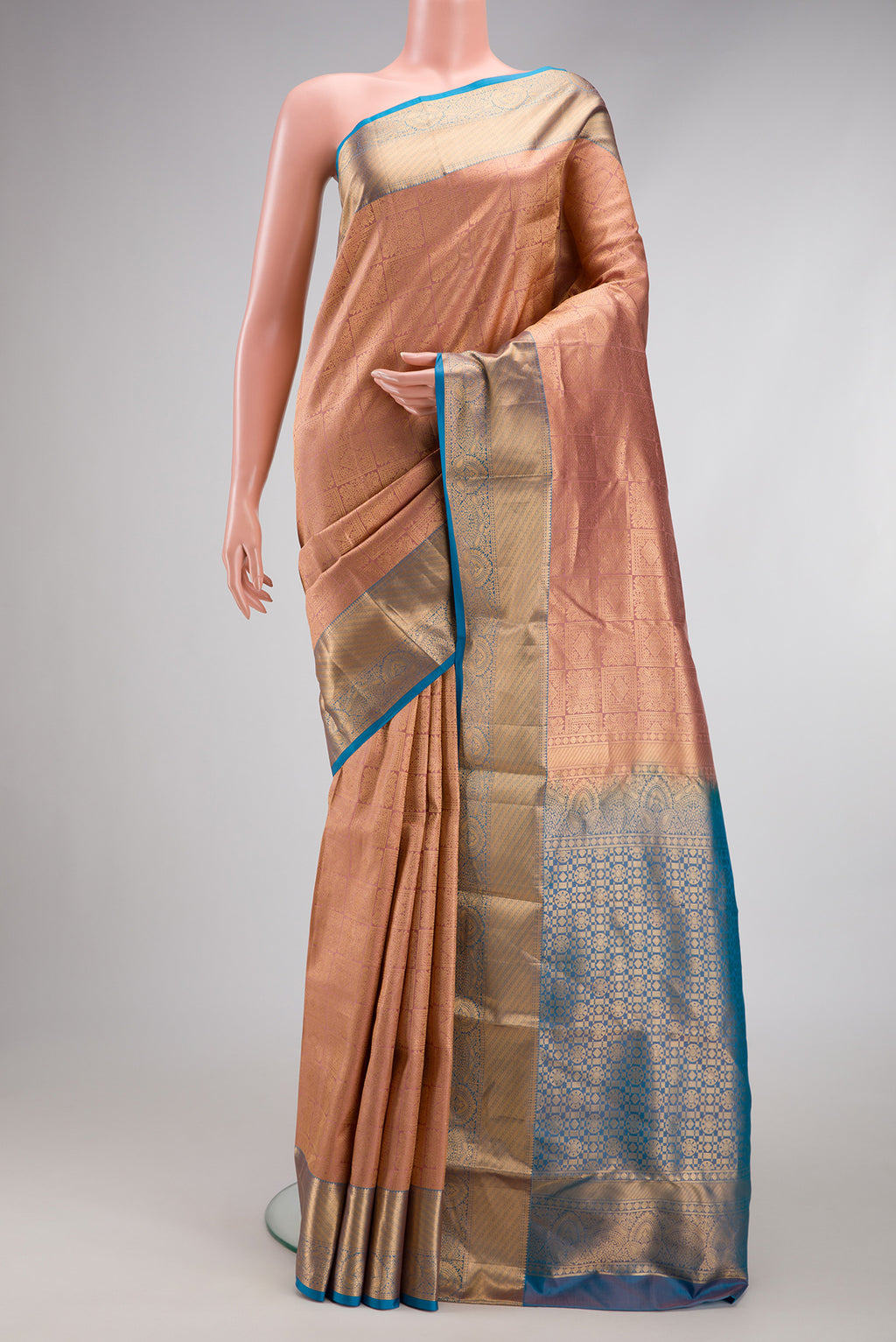 Rose Gold Kanchipuram Silk Saree with Zari Brocade on the body and Zari Border.  displayed on a mannequin