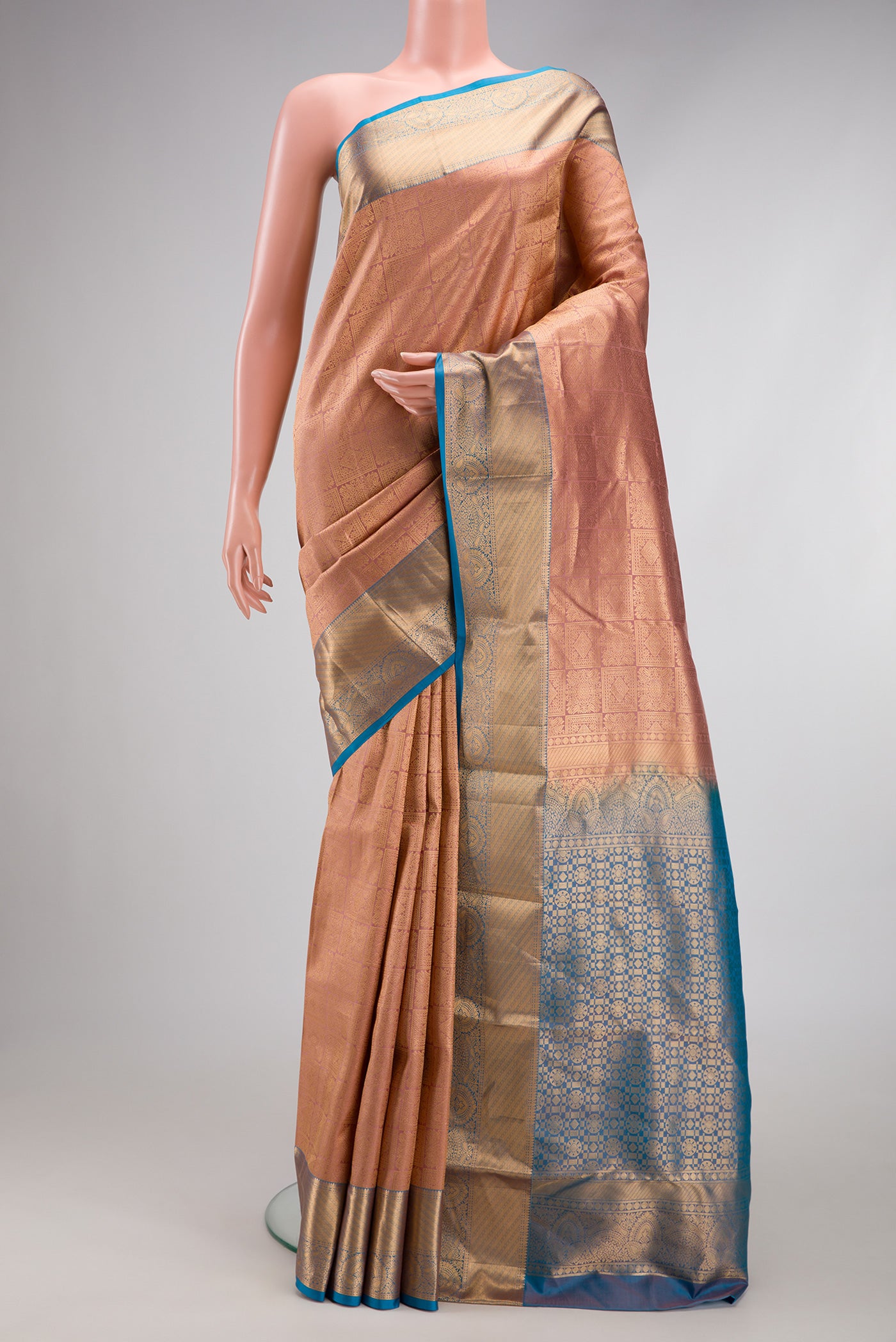 Rose Gold Kanchipuram Silk Saree with Zari Brocade on the body and Zari Border.  displayed on a mannequin