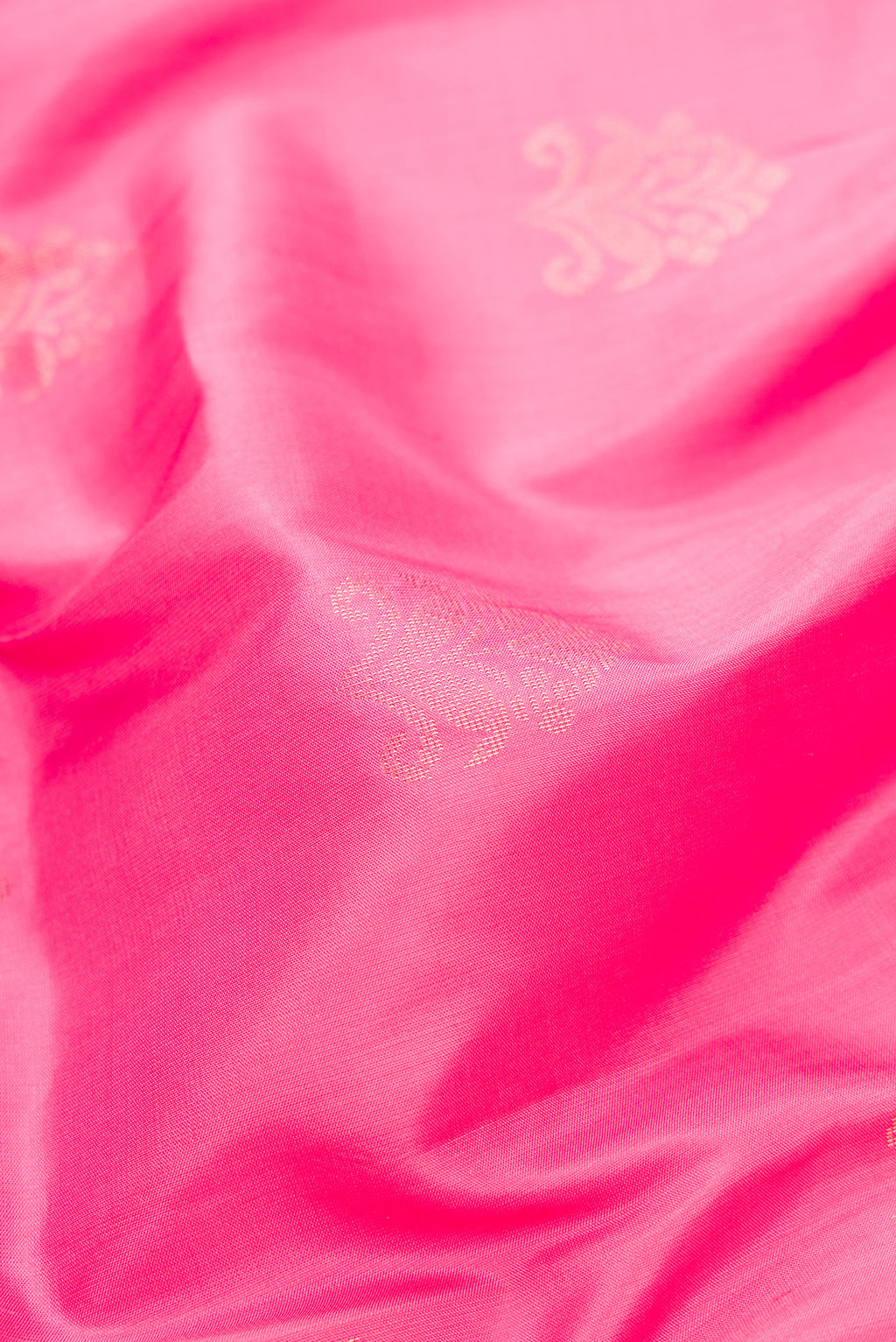 Close up of Pink Dual Tone Soft Silk Saree with Zari Butta on the body and Fancy Border.  displaying folds