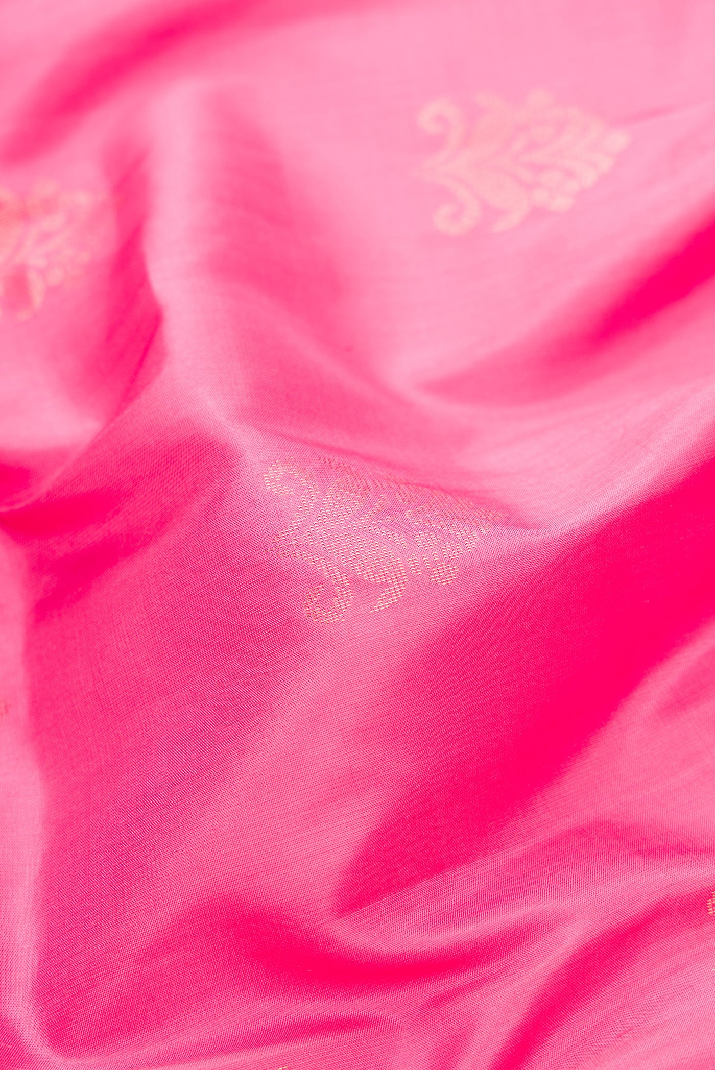 Close up of Pink Dual Tone Soft Silk Saree with Zari Butta on the body and Fancy Border.  displaying folds