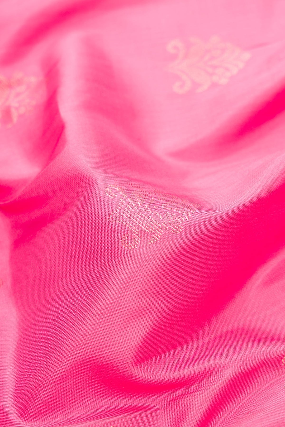Close up of Pink Dual Tone Soft Silk Saree with Zari Butta on the body and Fancy Border.  displaying folds