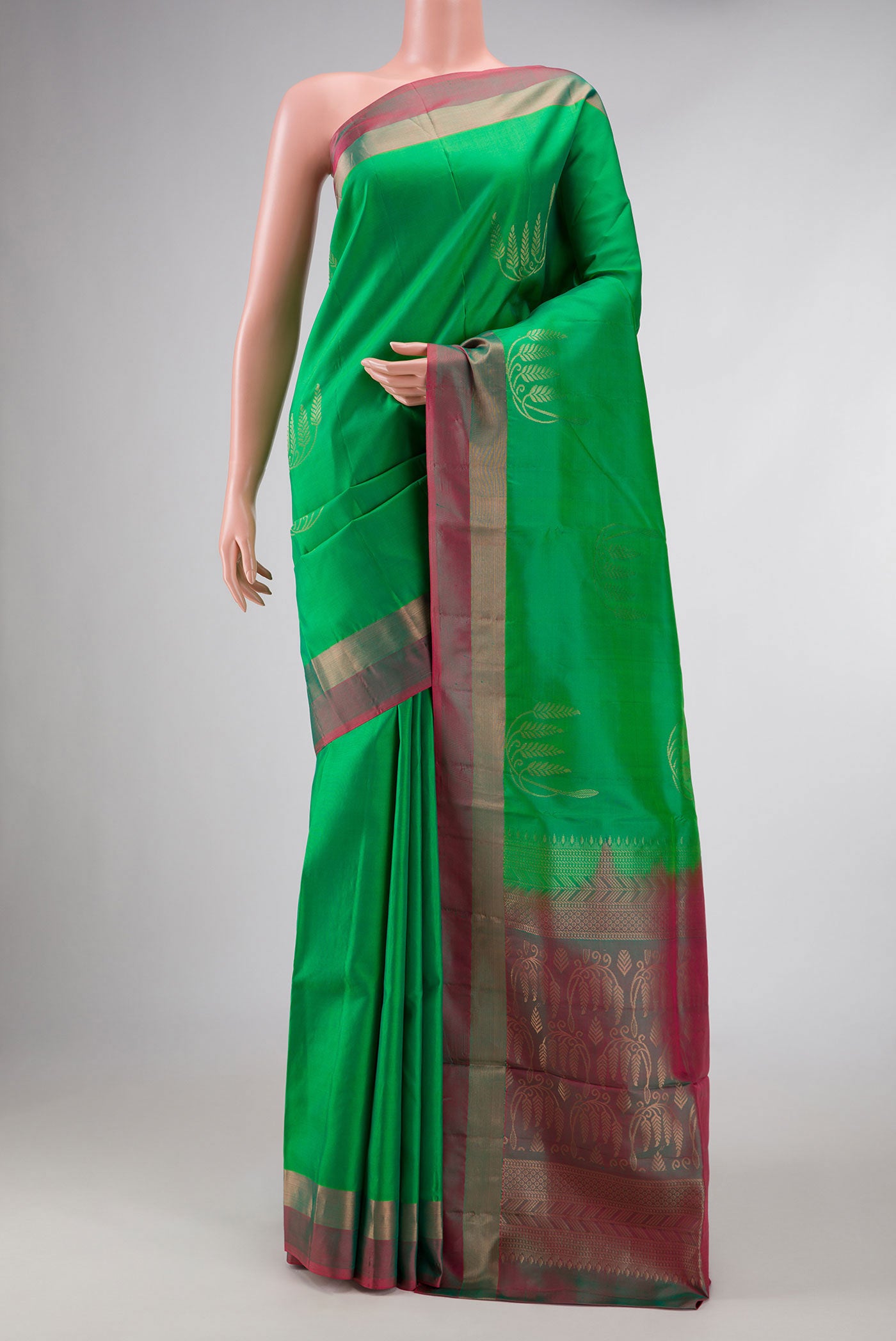 Green Dual Tone Soft Silk Saree with Zari Butta on the body and Zari Border displayed on a mannequin