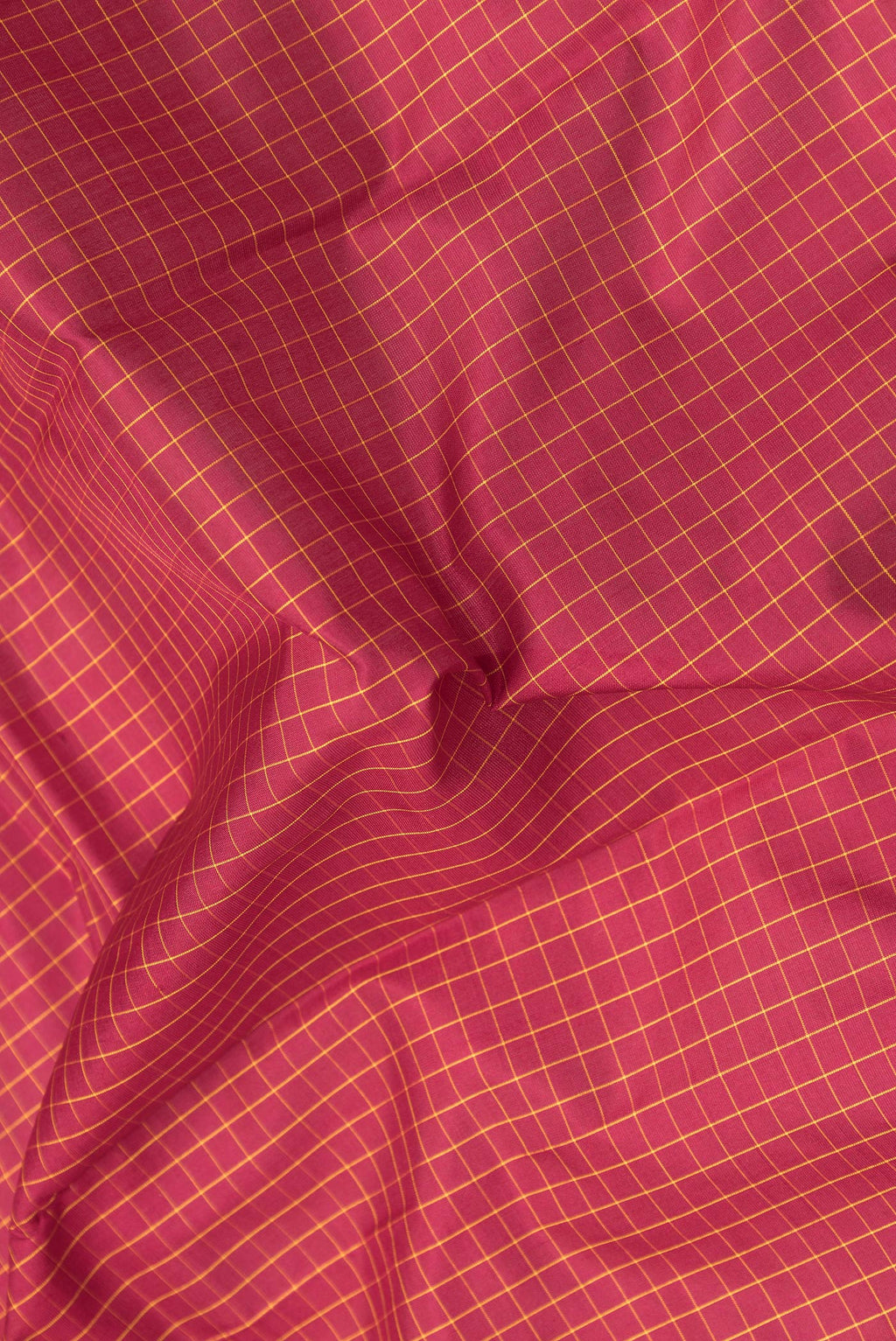 Close up of Maroon Kanchipuram Silk Saree with Checked design on the body and Zari Border.  displaying folds