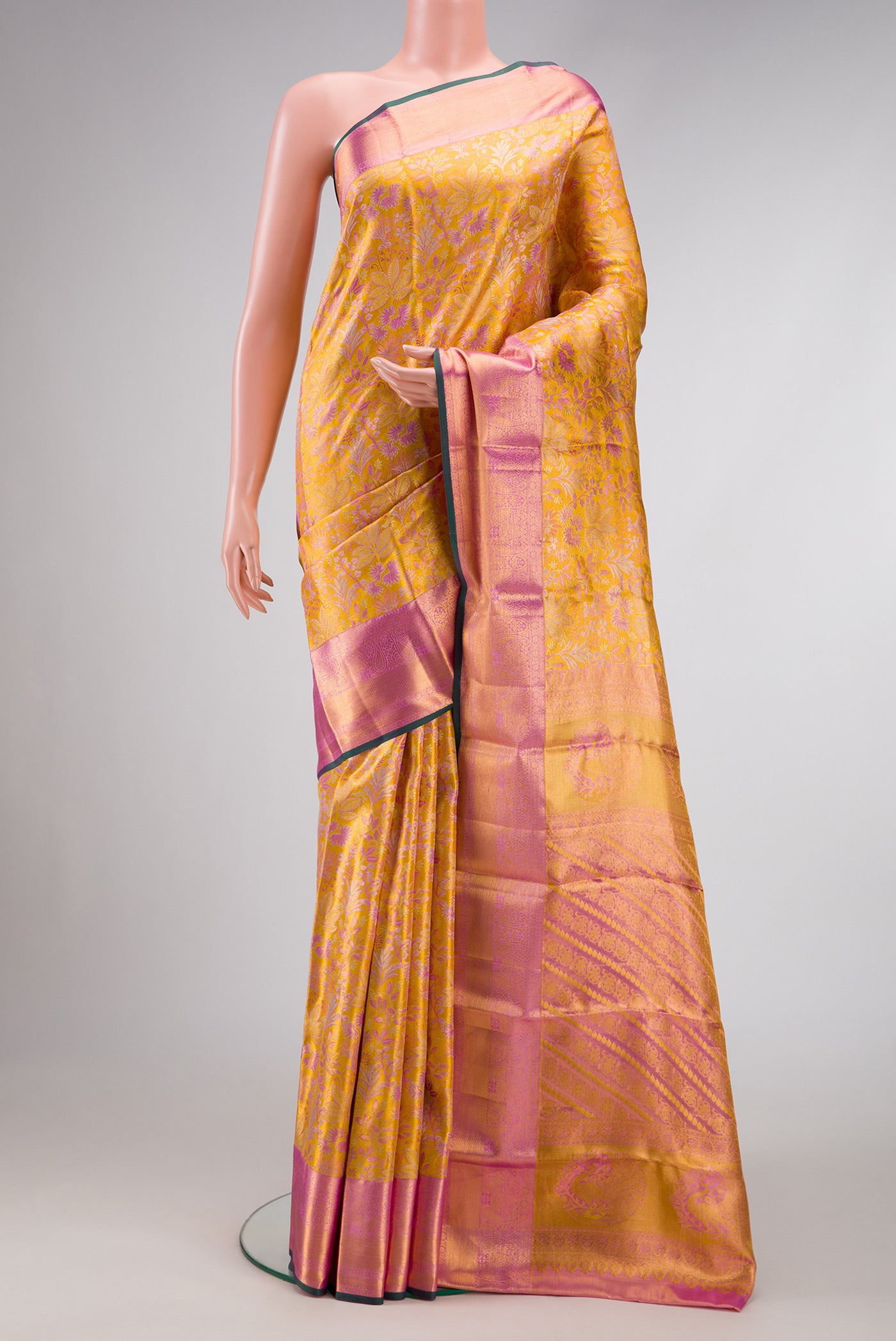 Gold Dual Tone Kanchipuram Tissue Silk Saree with Zari Brocade on the body and Zari Border.  displayed on a mannequin