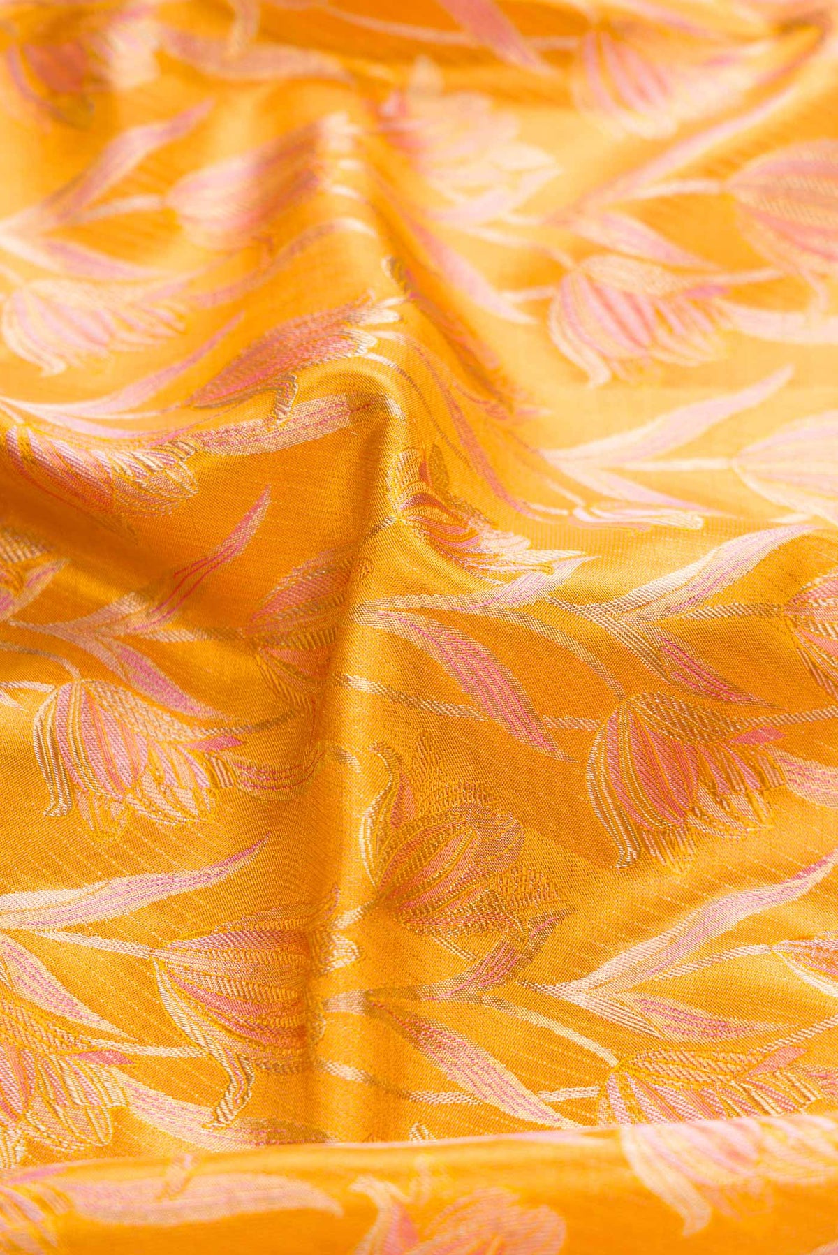 Close up of Mustard Dual Tone Kanchipuram Tissue Silk Saree with Zari Brocade on the body and Zari Border displaying folds