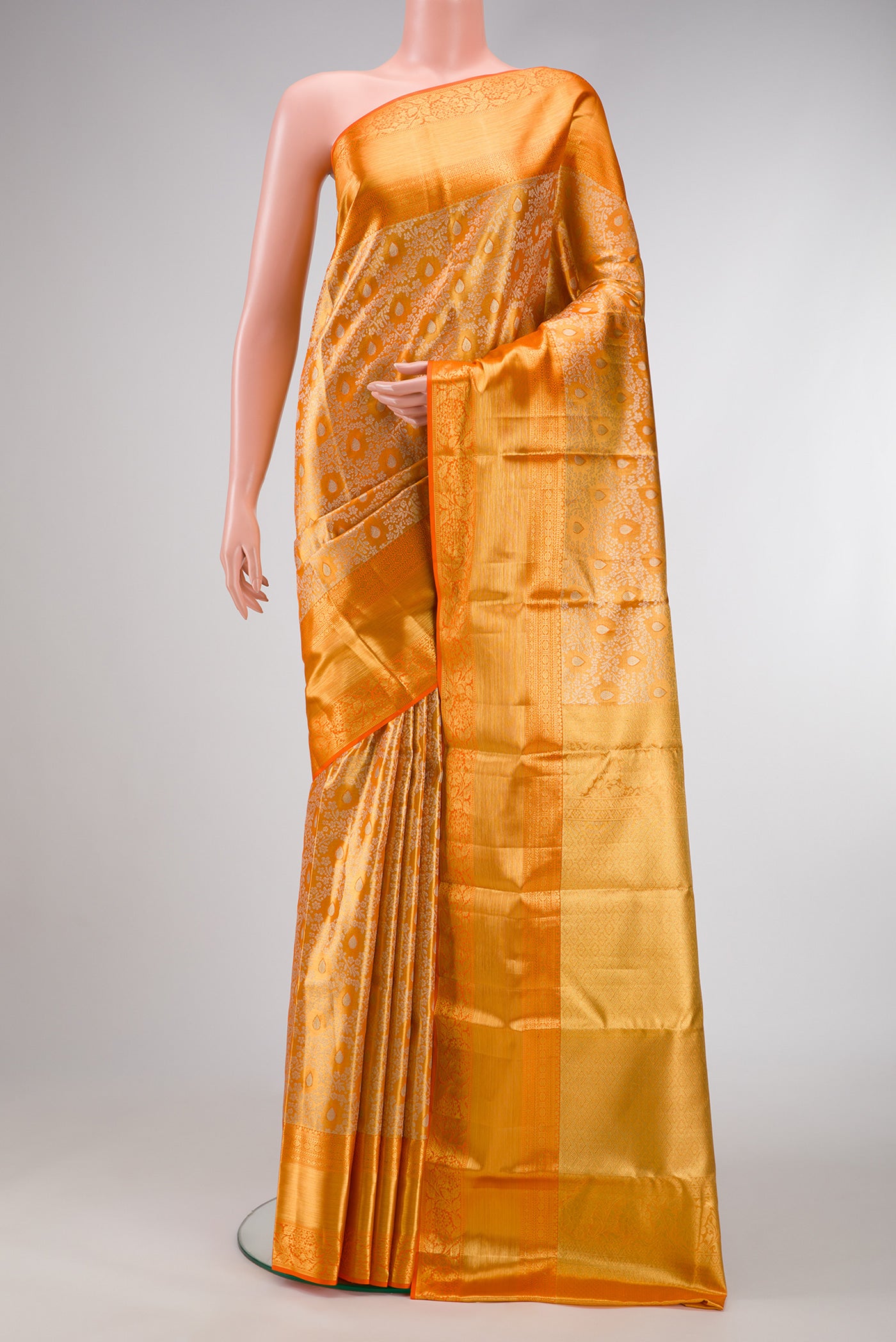 Orange Dual Tone Kanchipuram Tissue Silk Saree with Zari Brocade on the body and Zari Border.  displayed on a mannequin