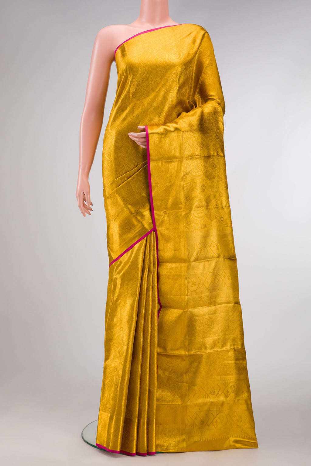 Gold Dual Tone Kanchipuram Tissue Silk Saree with Zari Brocade on the body and Zari Border.  displayed on a mannequin