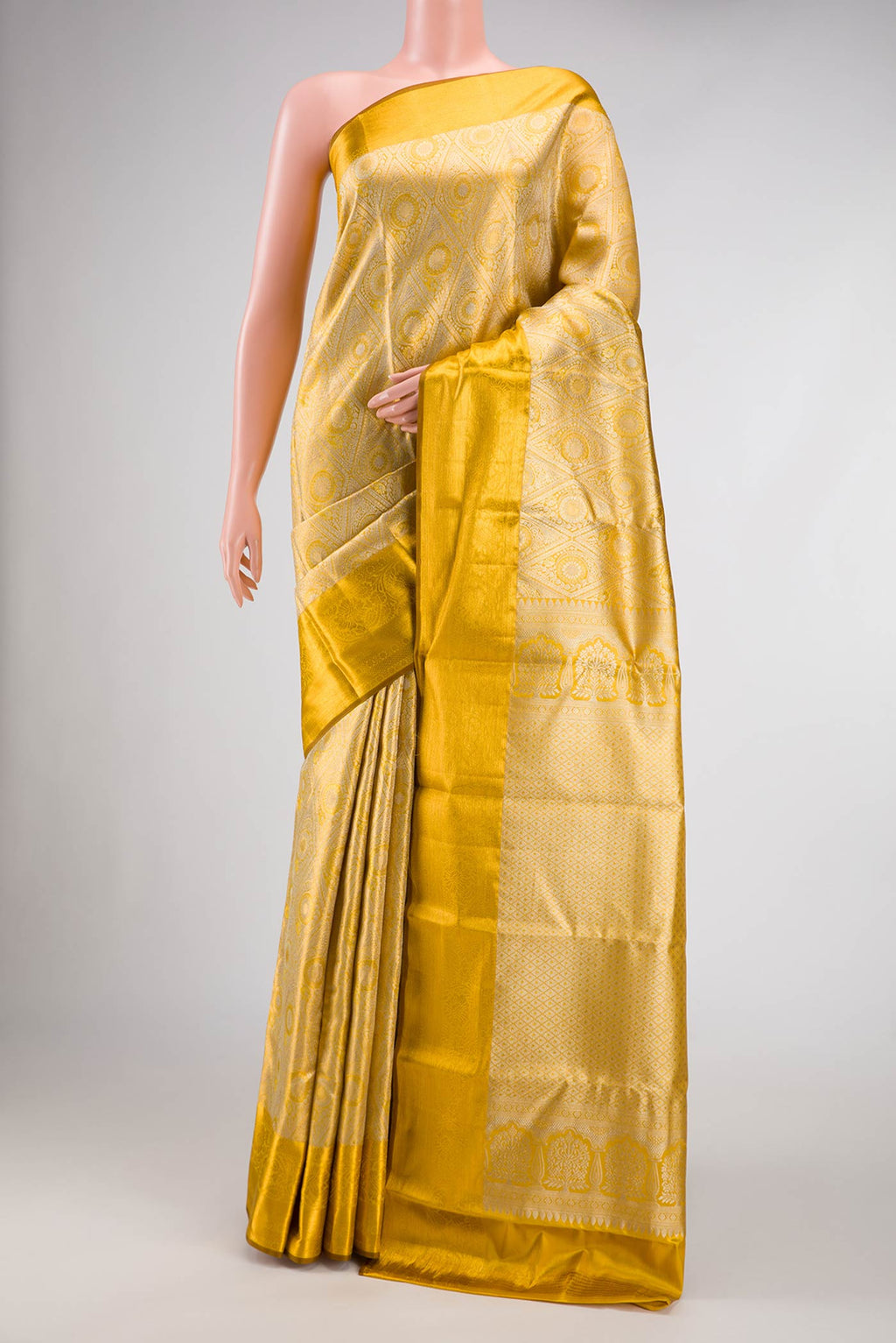 Gold Dual Tone Kanchipuram Tissue Silk Saree with Zari Brocade on the body and Zari Border.  displayed on a mannequin