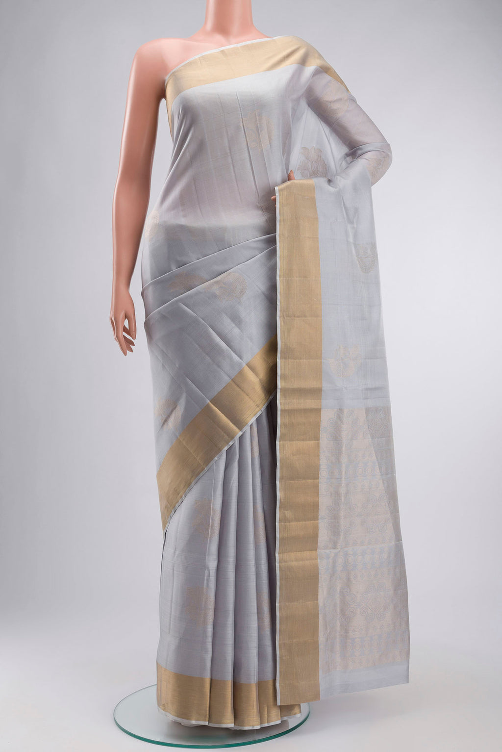 Light Blue Soft Silk Saree with Zari Butta on the body and Zari Border displayed on a mannequin