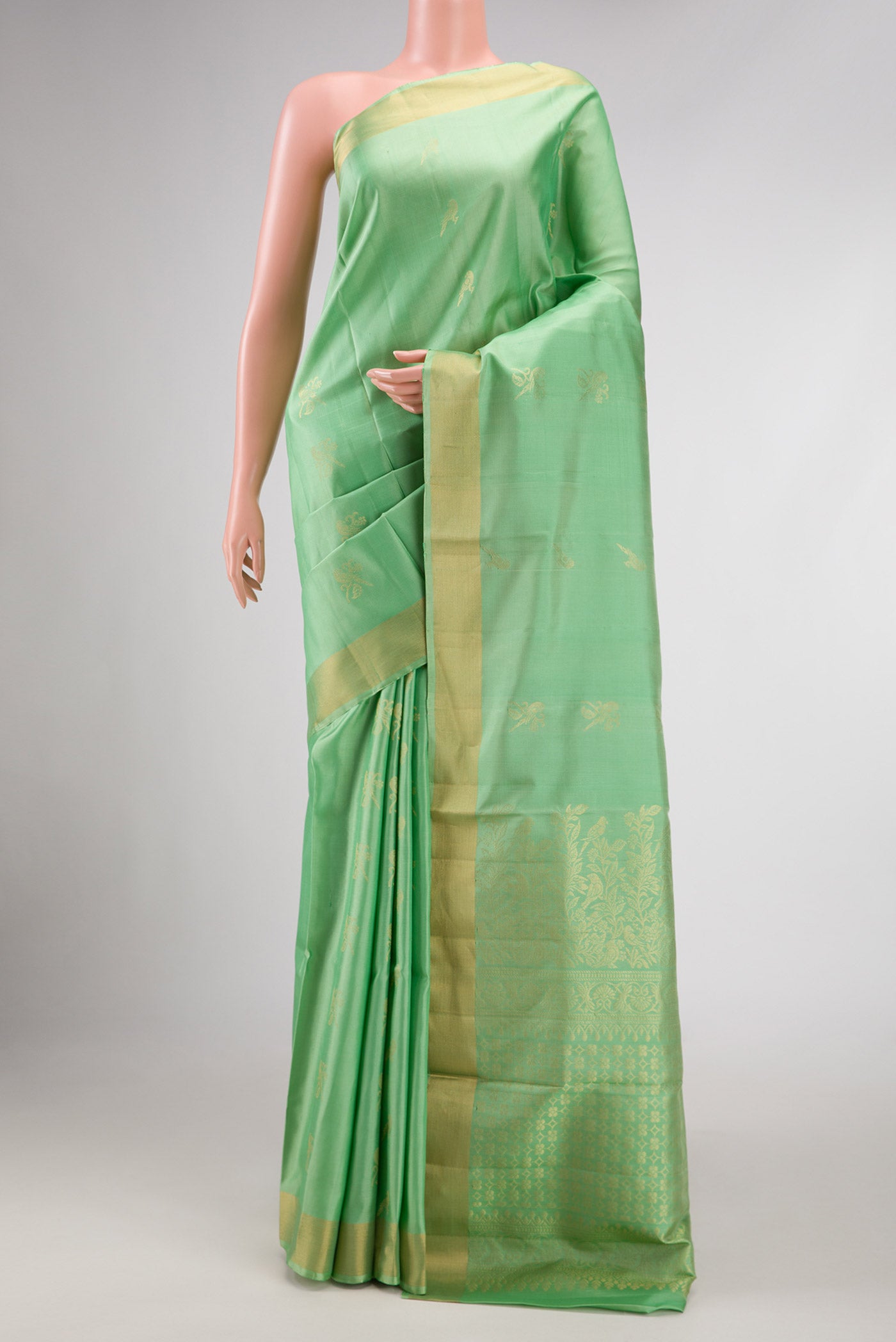 Pista Green Dual Tone Soft Silk Saree with Zari Butta on the body and Zari Border displayed on a mannequin