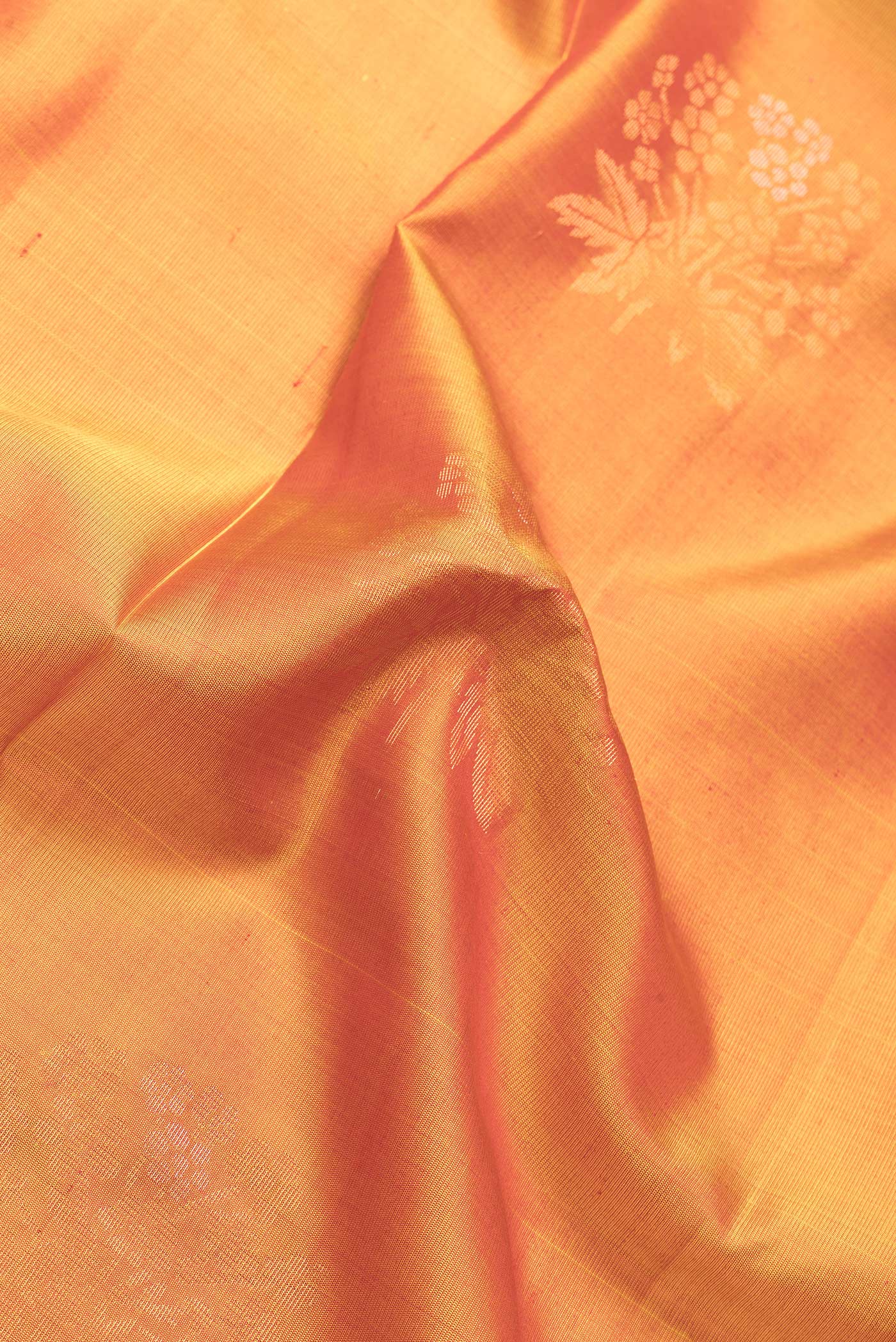 Close up of Mustard Dual Tone Soft Silk Saree with Zari Butta on the body and Zari Border.  displaying folds