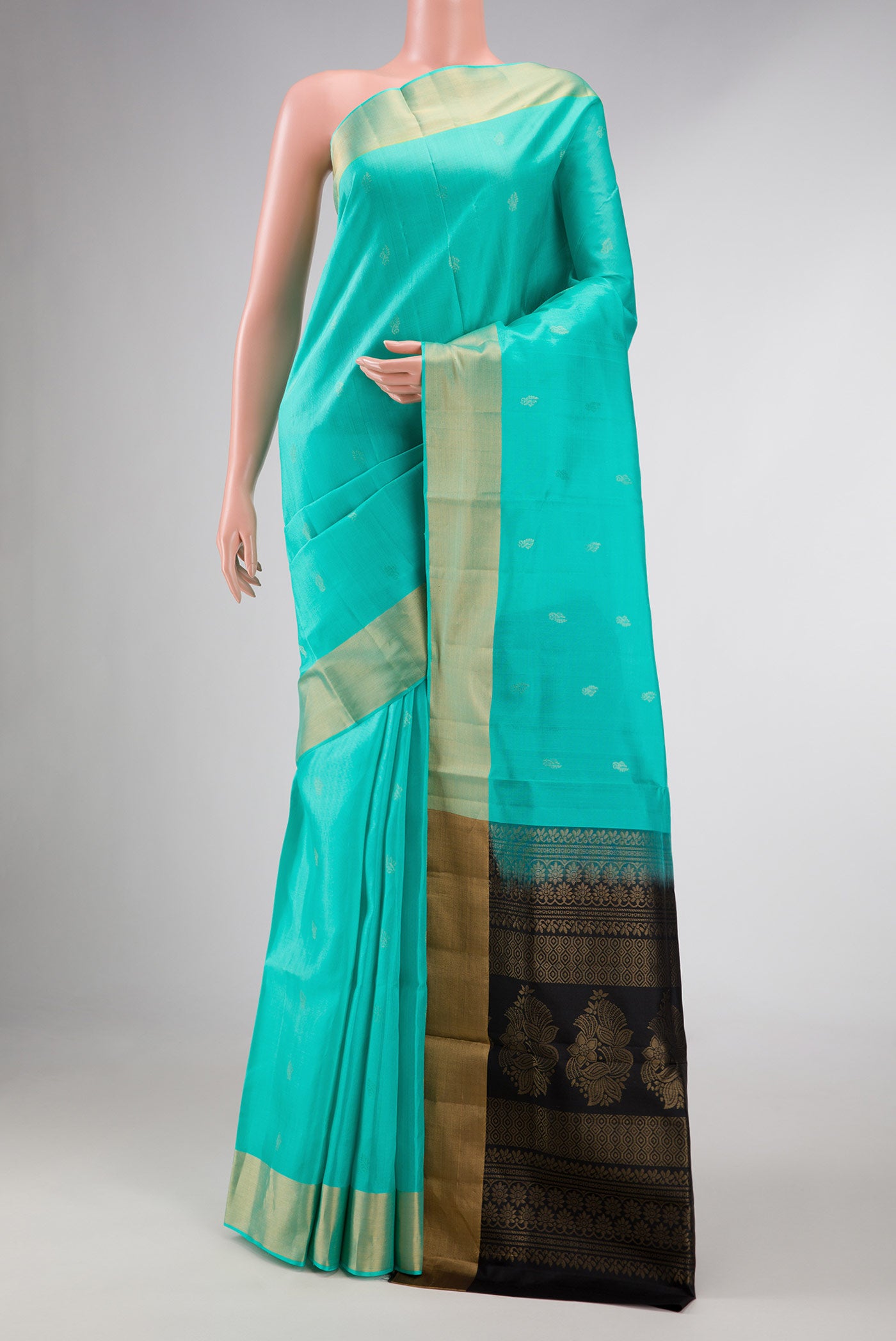 Sea Green Dual Tone Soft Silk Saree with Zari Butta on the body and Zari Border displayed on a mannequin