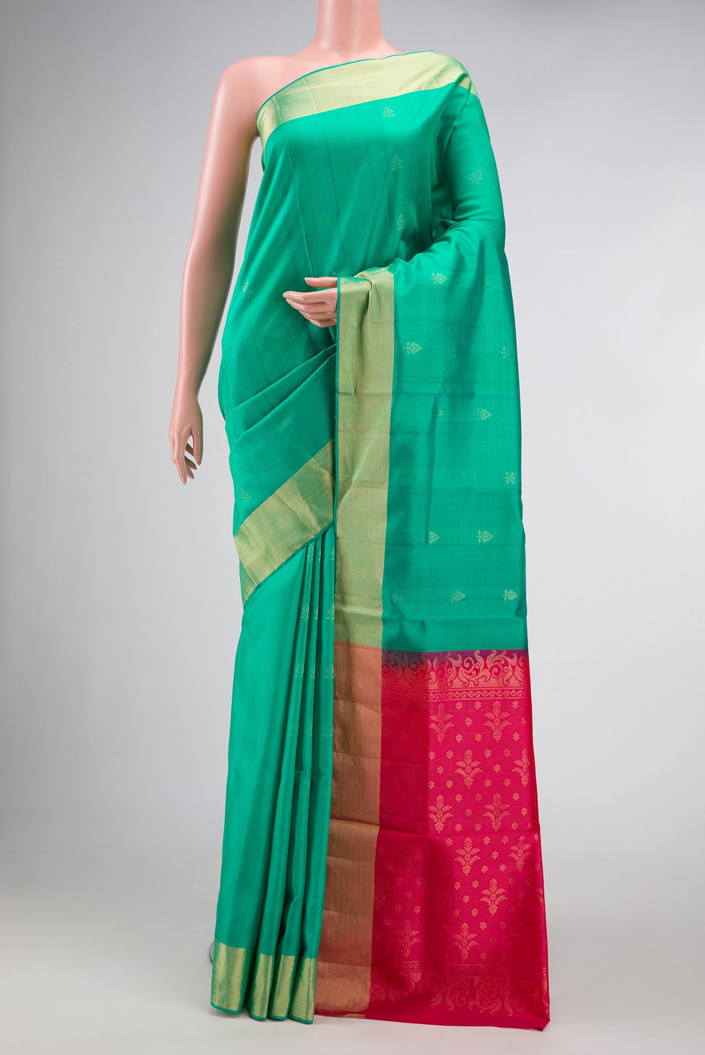 Green Dual Tone Soft Silk Saree with Zari Butta on the body and Zari Border.  displayed on a mannequin