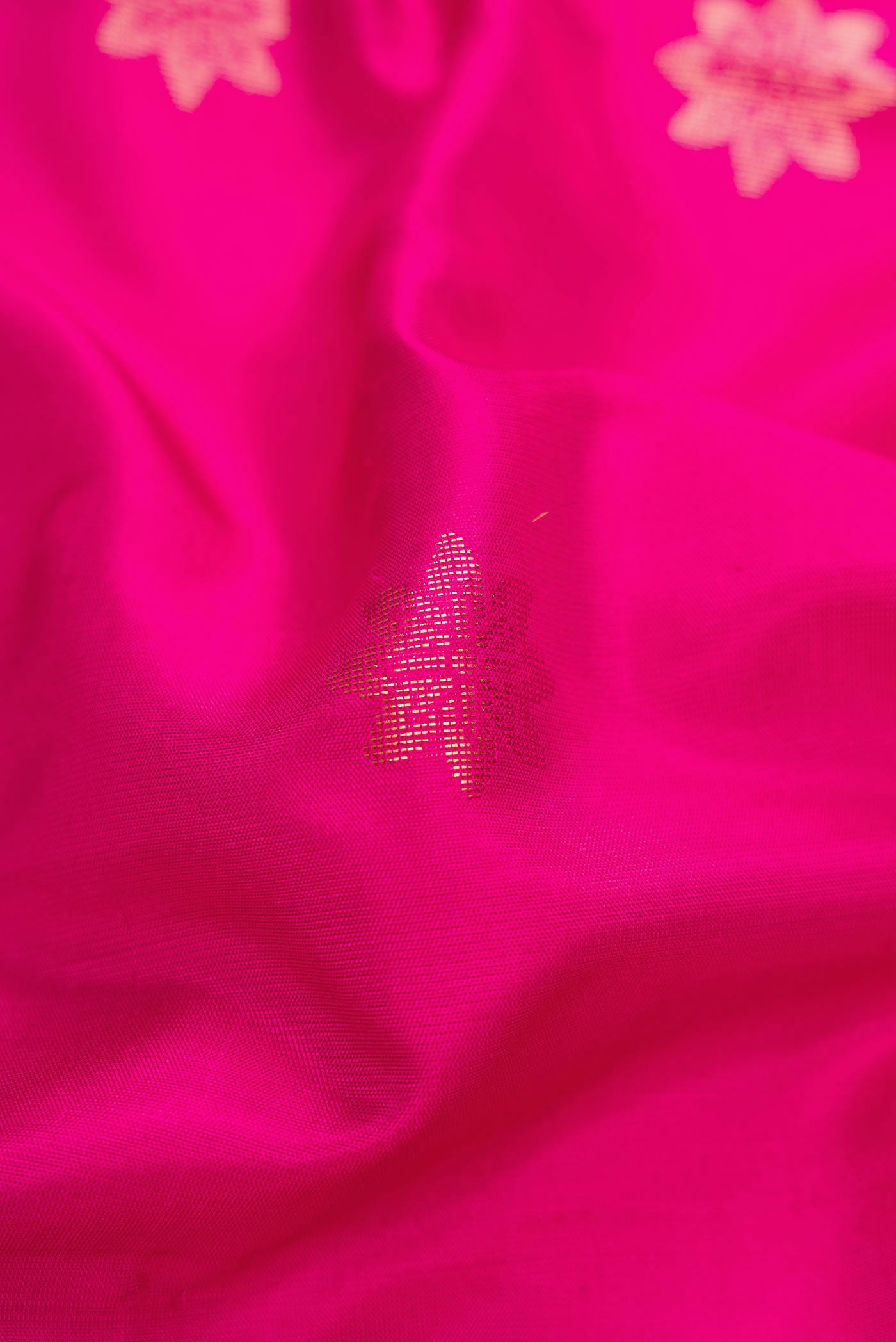 Close up of Pink Dual Tone Soft Silk Saree with Zari Butta on the body and Zari Border.  displaying folds