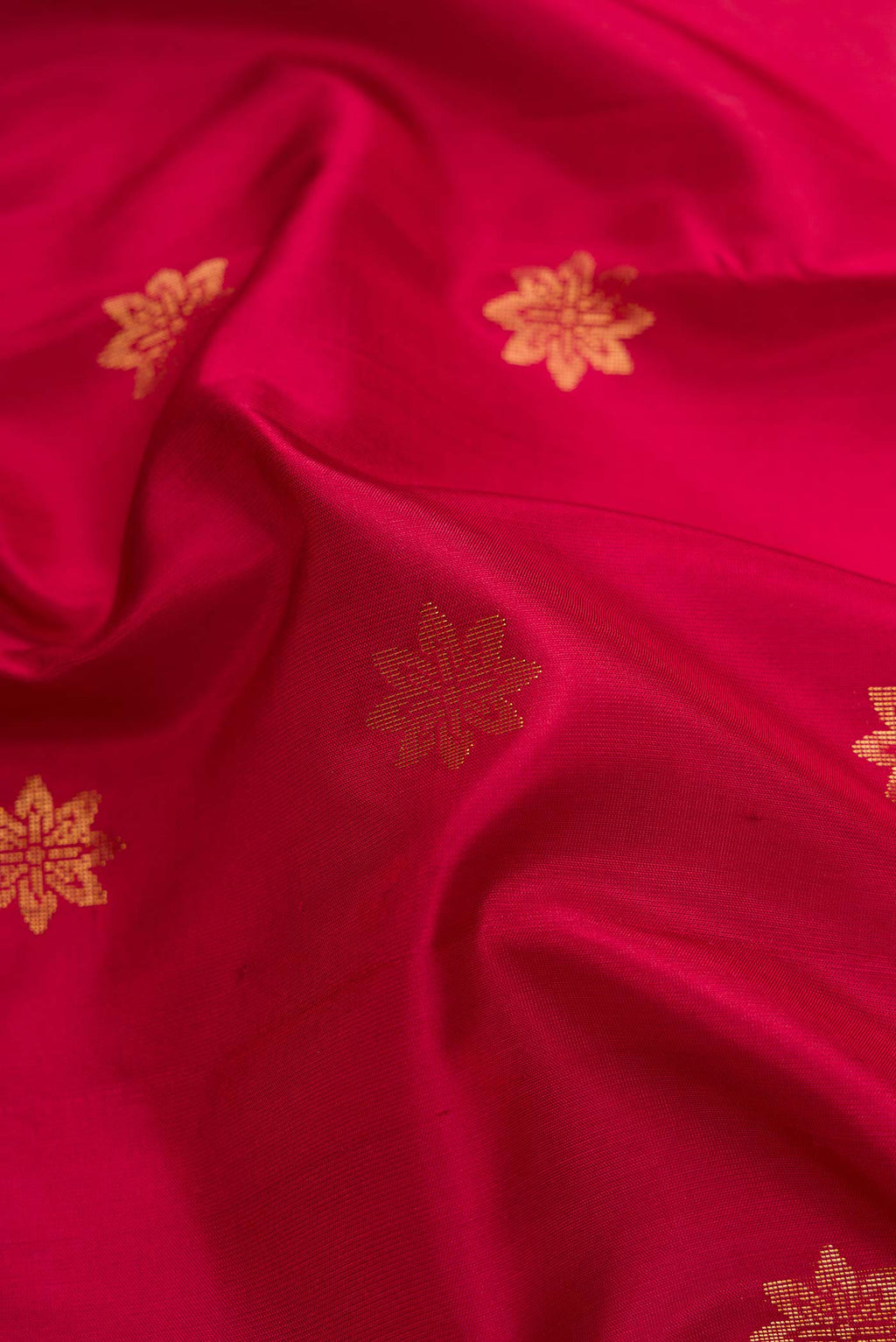 Close up of Maroon Dual Tone Soft Silk Saree with Zari Butta on the body and Zari Border.  displaying folds