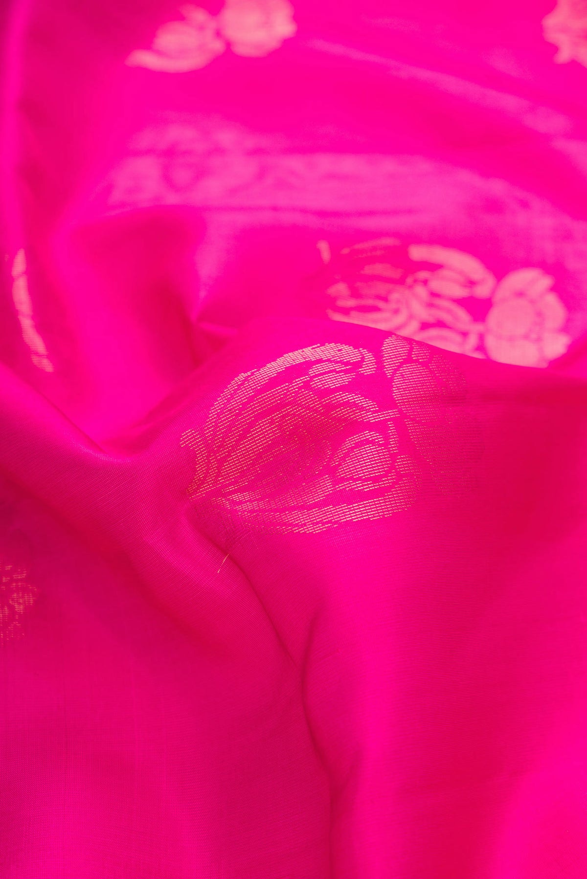 Close up of Pink Dual Tone Soft Silk Saree with Zari Butta on the body and Zari Border displaying folds