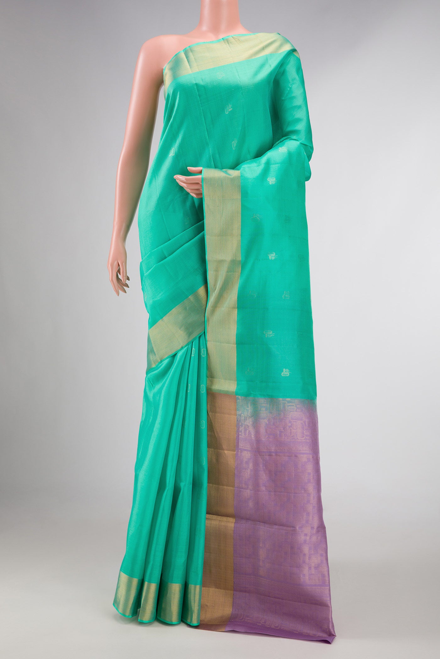Sea Green Dual Tone Soft Silk Saree with Zari Butta on the body and Zari Border displayed on a mannequin