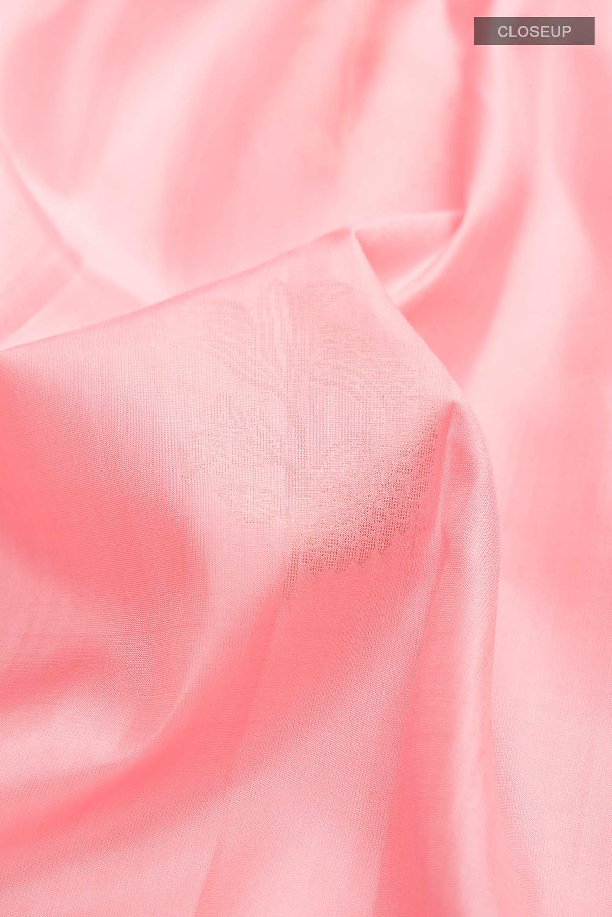 Close up of Rose pink Soft Silk Saree with Zari Butta on the body and Zari Border displaying folds