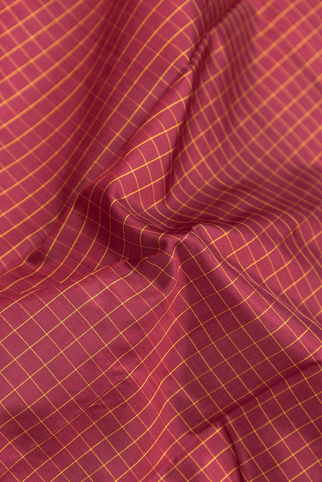 Close up of Maroon Kanjivaram Silk Saree with Checked design on the body and Zari Border.  displaying folds