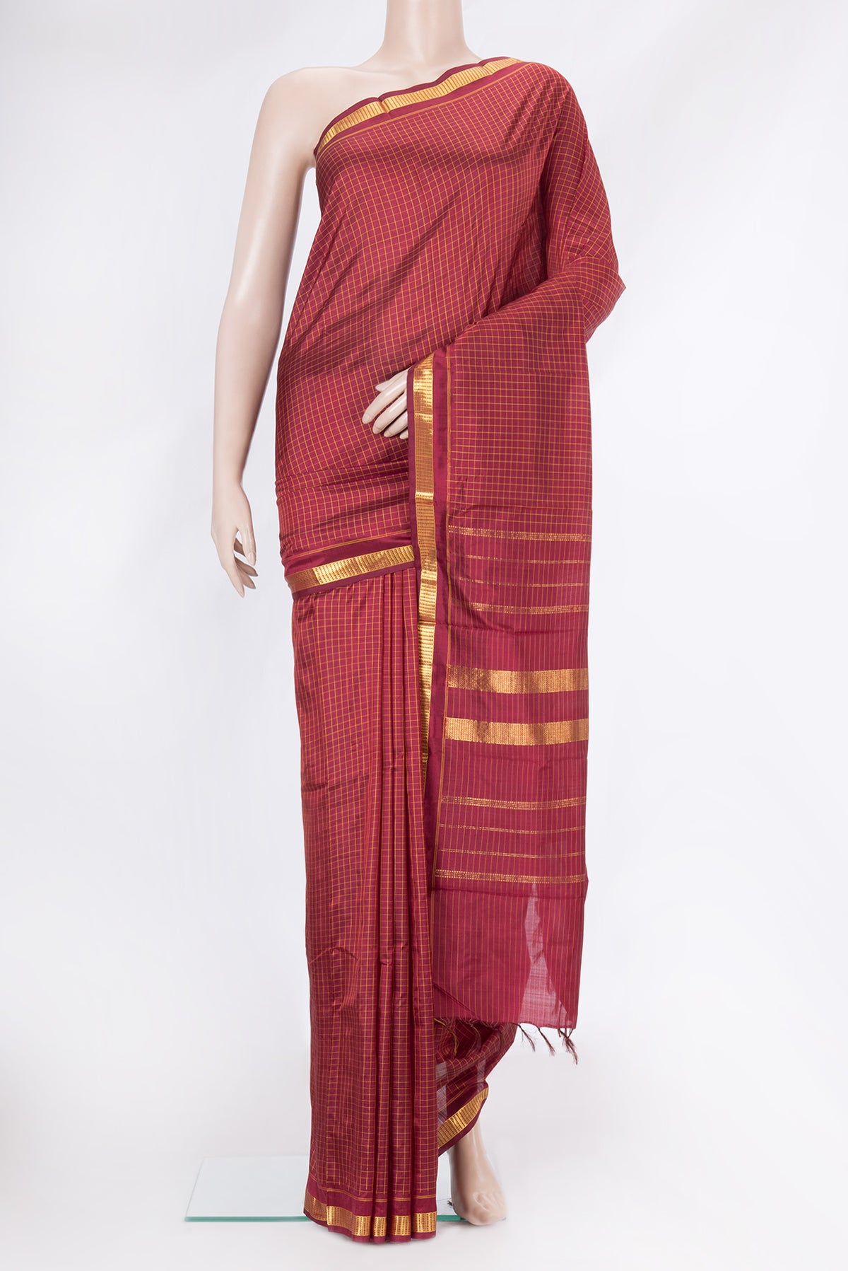 Maroon Kanjivaram Silk Saree with Checked design on the body and Zari Border.  displayed on a mannequin