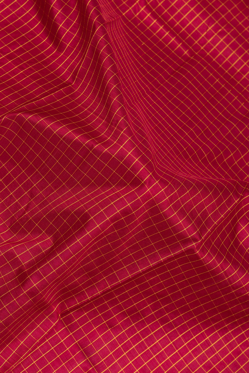 Close up of Maroon Kanjivaram Silk Saree with Checked design on the body and Zari Border.  displaying folds
