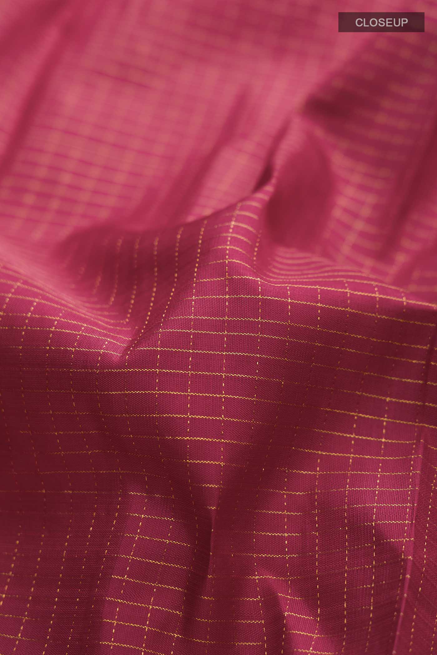 Close up of Maroon Kanchipuram Silk Saree with Stripes on the body and Zari Border displaying folds