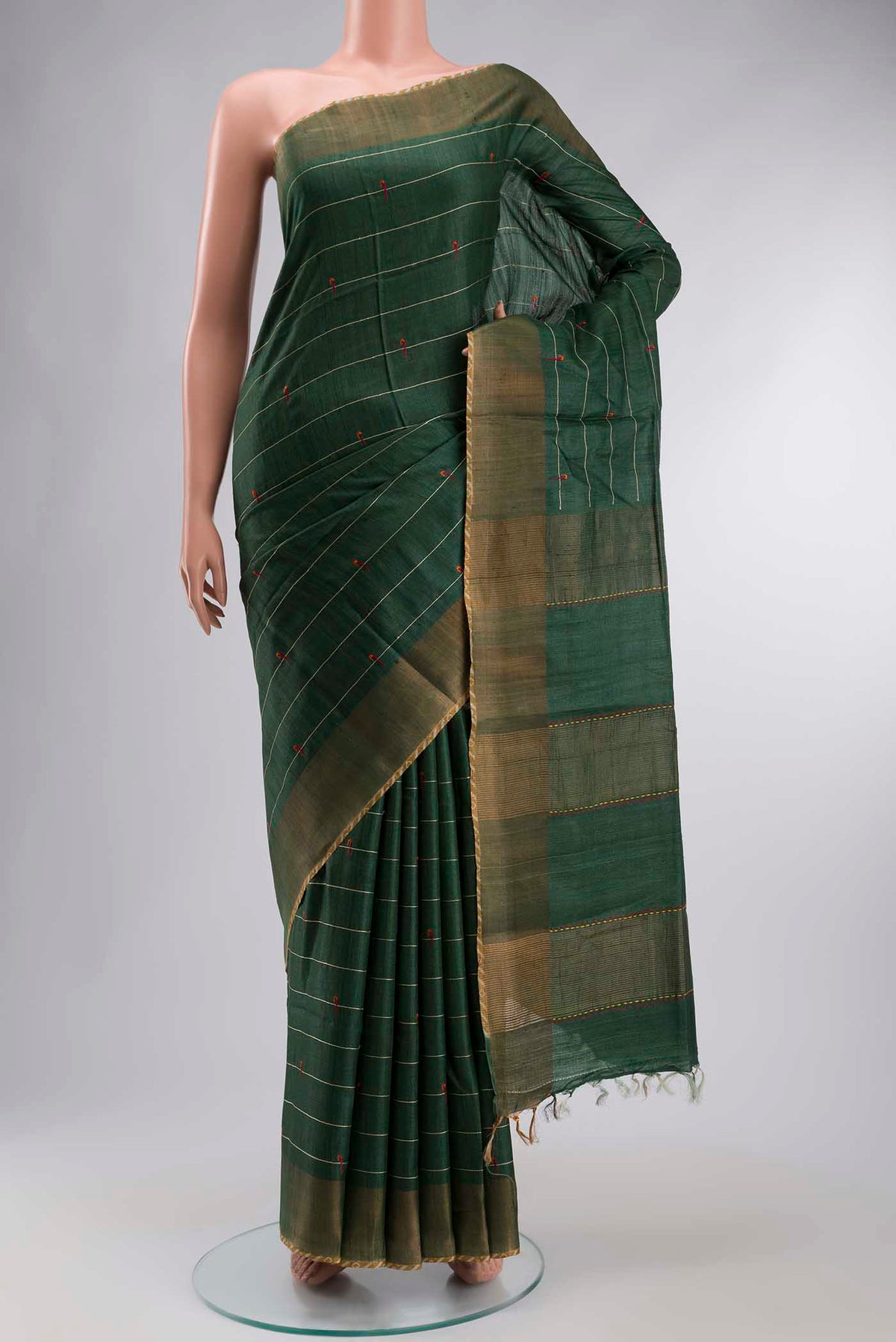 Green Tussar Silk Saree with Stripes on the body and Zari Border displayed on a mannequin