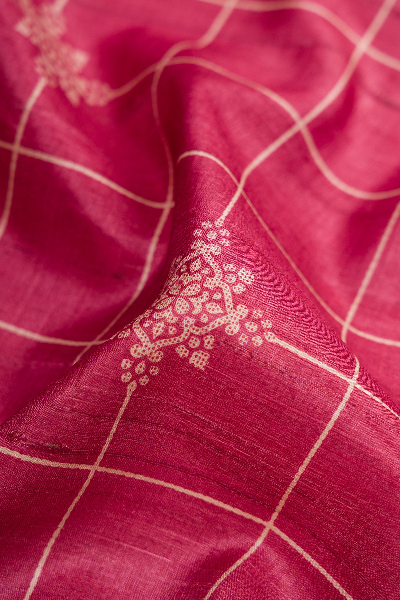 Close up of Pink Dual Tone Tussar Silk Saree with Checked design on the body and Zari Border.  displaying folds