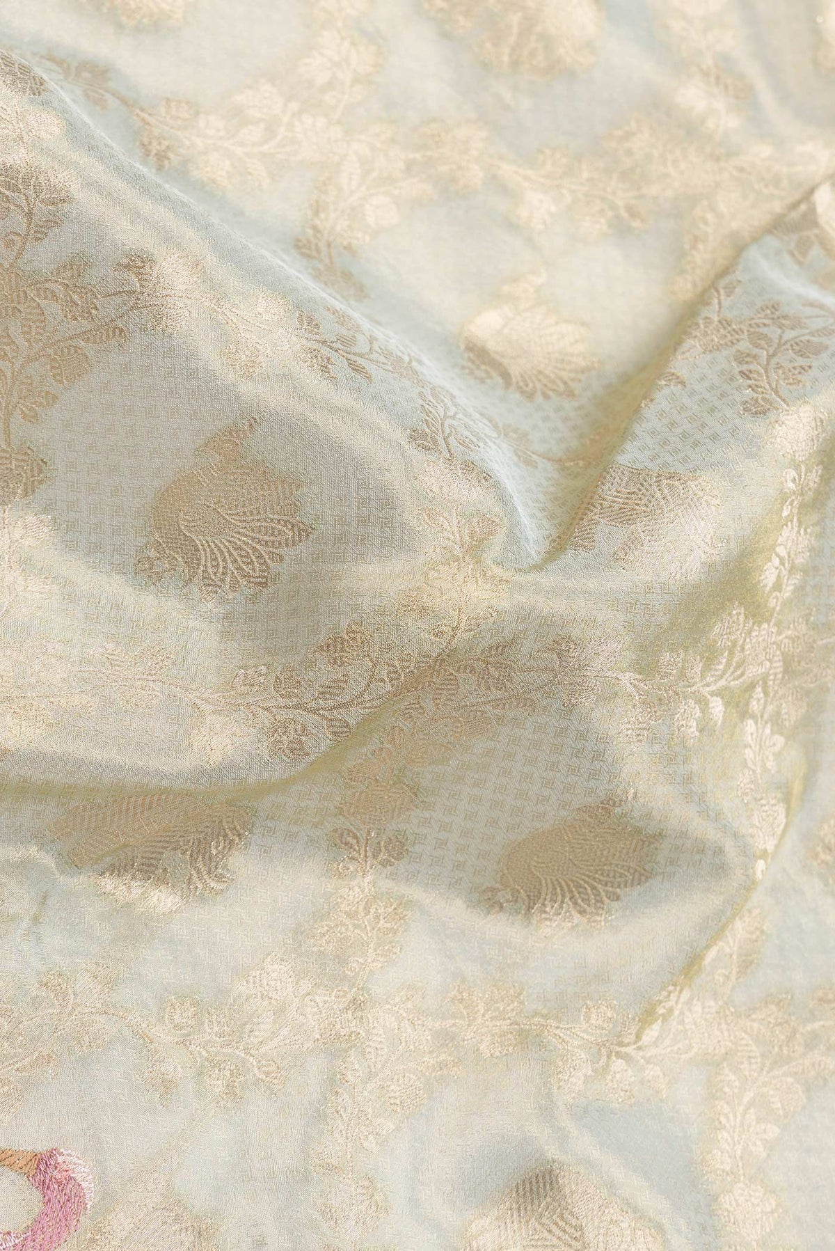Close up of Pista Green Dual Tone Organza Silk Saree with Zari Brocade on the body and Embroidery Border.  displaying folds