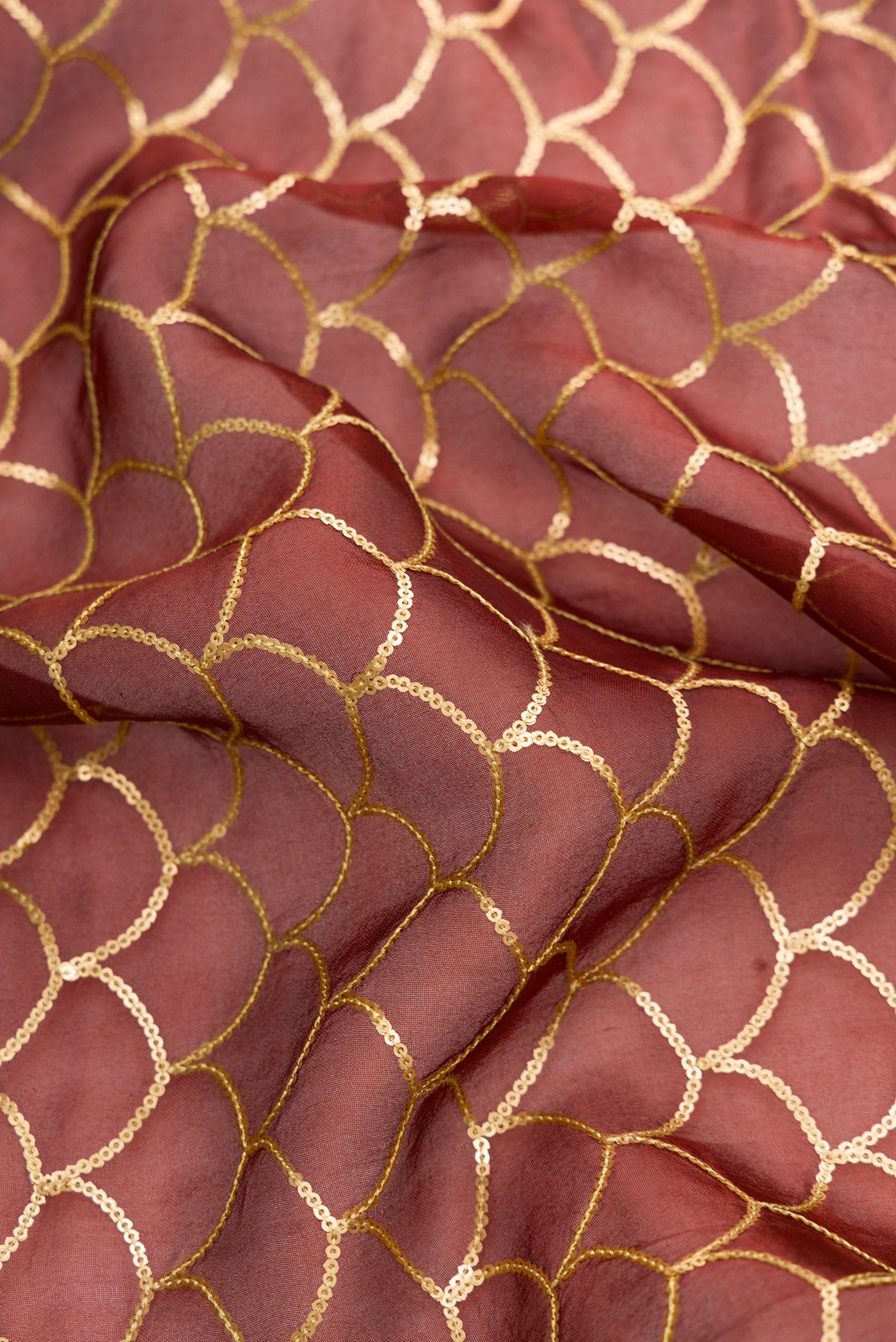 Close up of Maroon Dual Tone Organza Silk Saree with Embroidery on the body and Embroidery Border.  displaying folds