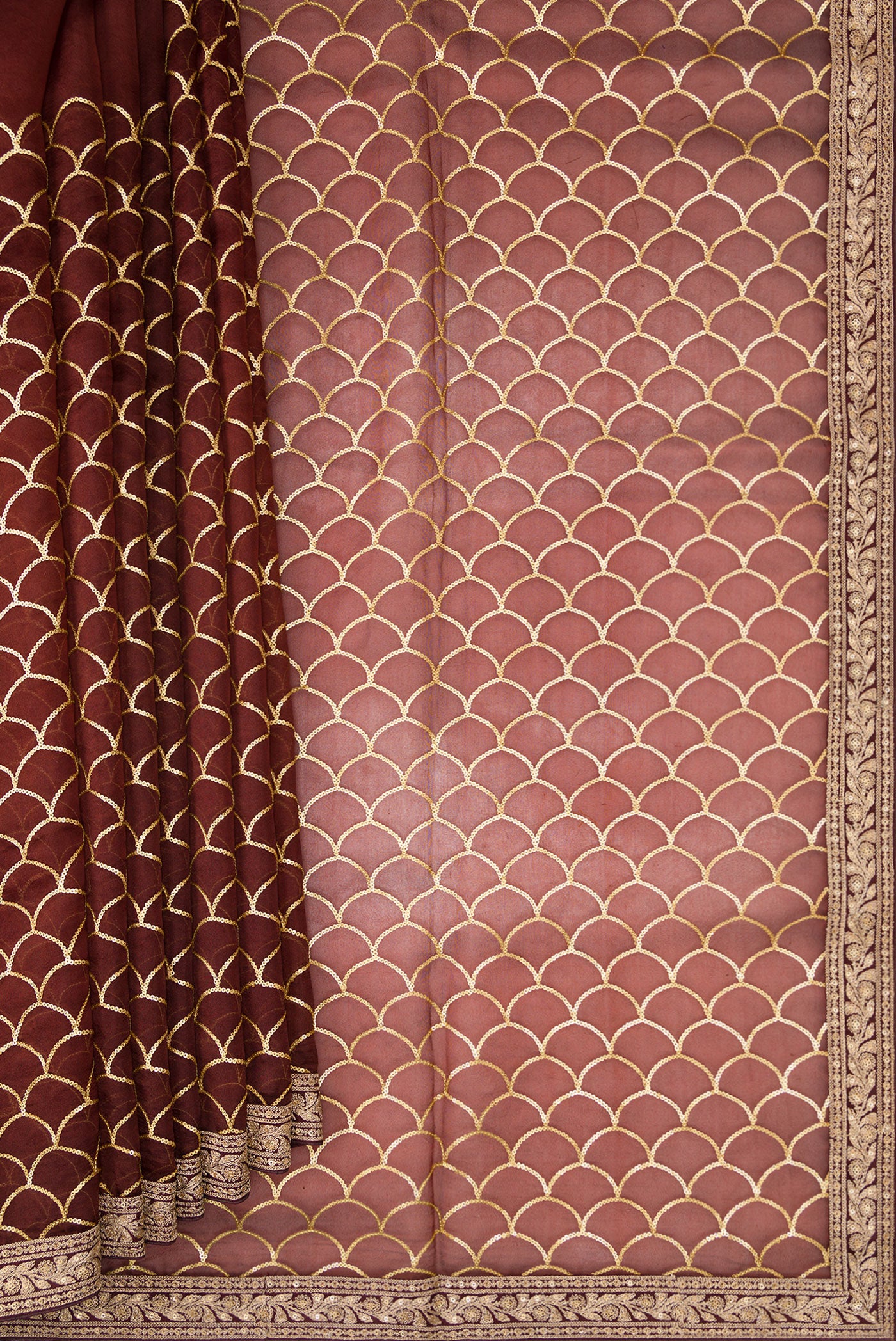 Pleats and pallu of Maroon Dual Tone Organza Silk Saree with Embroidery on the body and Embroidery Border. 