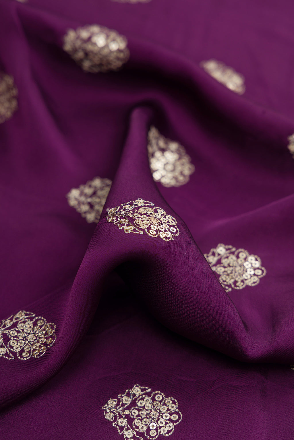 Close up of Purple Dual Tone Crepe Saree with Embroidery on the body and Embroidery Border.  displaying folds