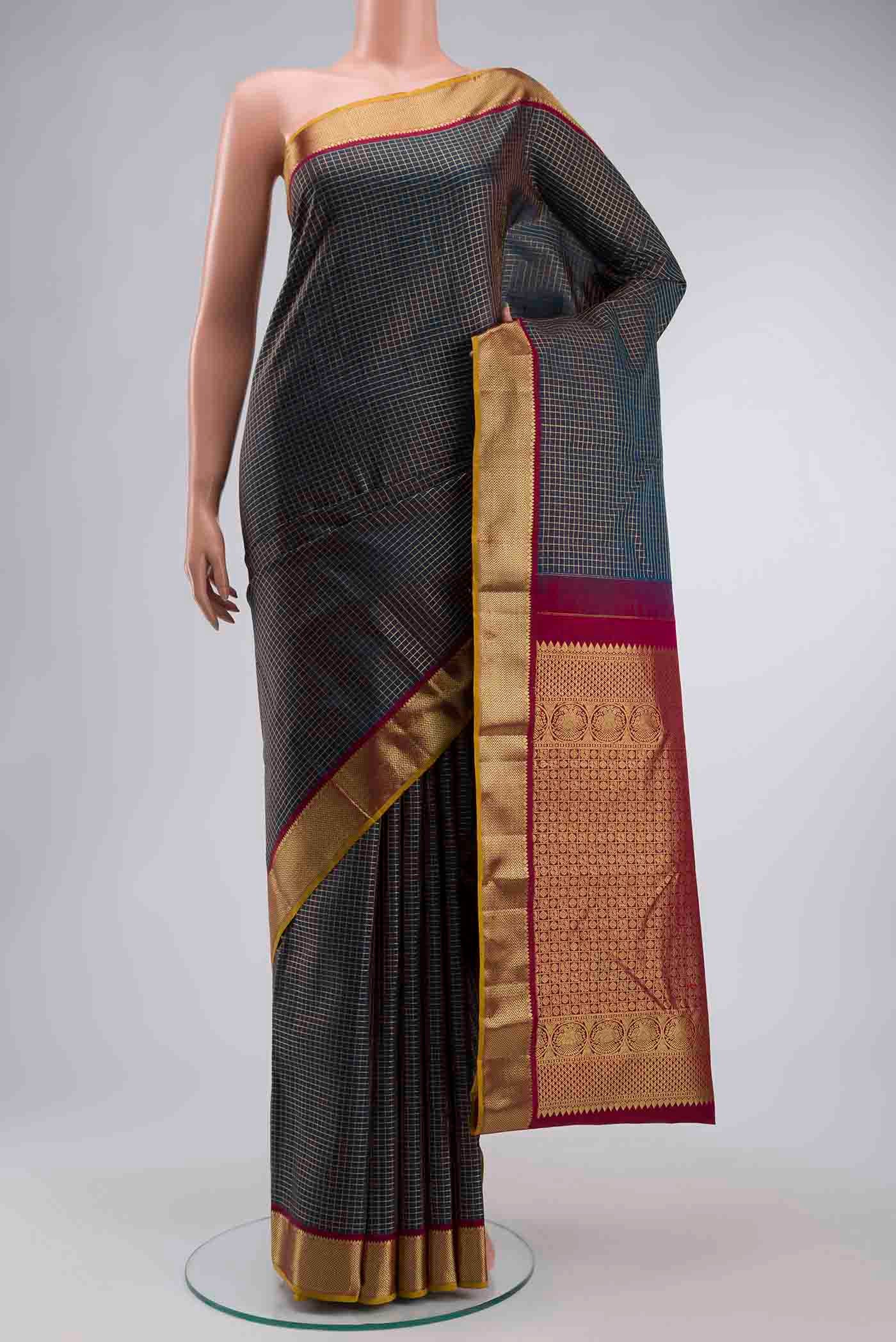 Blue Kanchipuram Silk Saree with Checked design on the body and Zari Border displayed on a mannequin