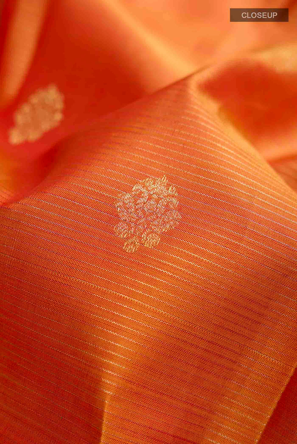 Close up of Mustard Kanchipuram Silk Saree with Stripes on the body and Zari Border displaying folds