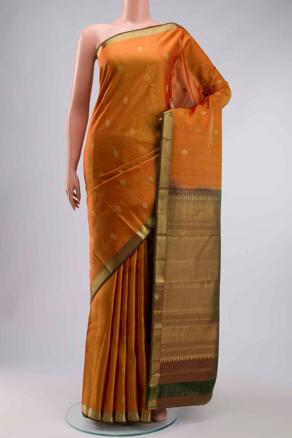 Mustard Kanchipuram Silk Saree with Stripes on the body and Zari Border displayed on a mannequin