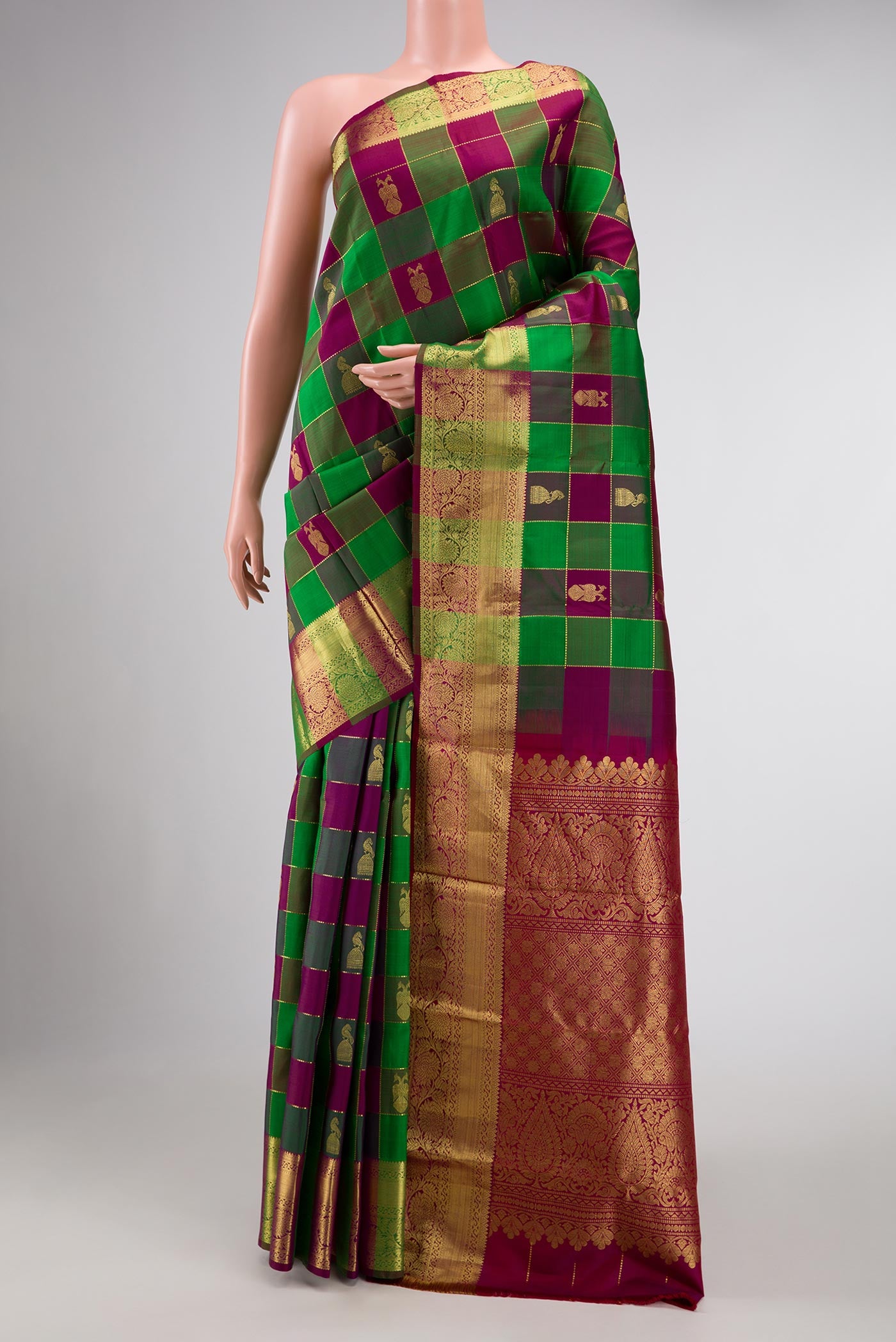 Green and Purple Color Kanchipuram Silk Saree with Checked design on the body and Zari Border displayed on a mannequin