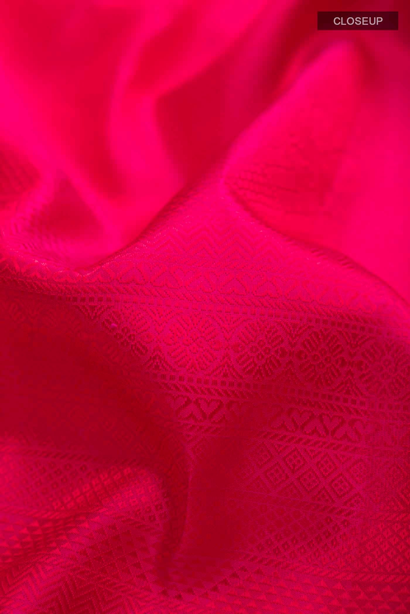 Close up of Pink Kanchipuram Silk Saree with Jacquard design on the body and Zari Border displaying folds
